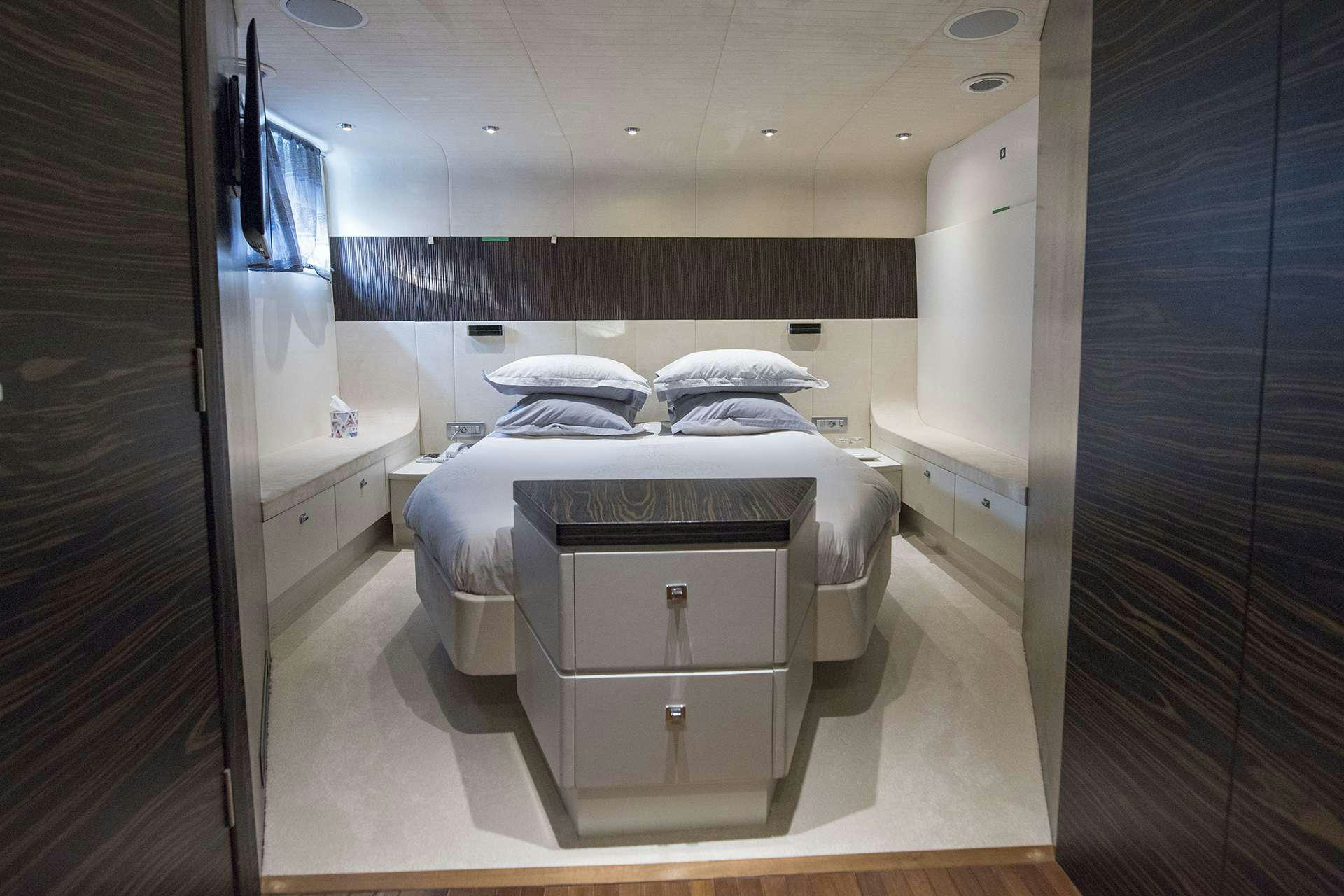 a room with a bed and a mirror aboard ONE BLUE Yacht for Charter