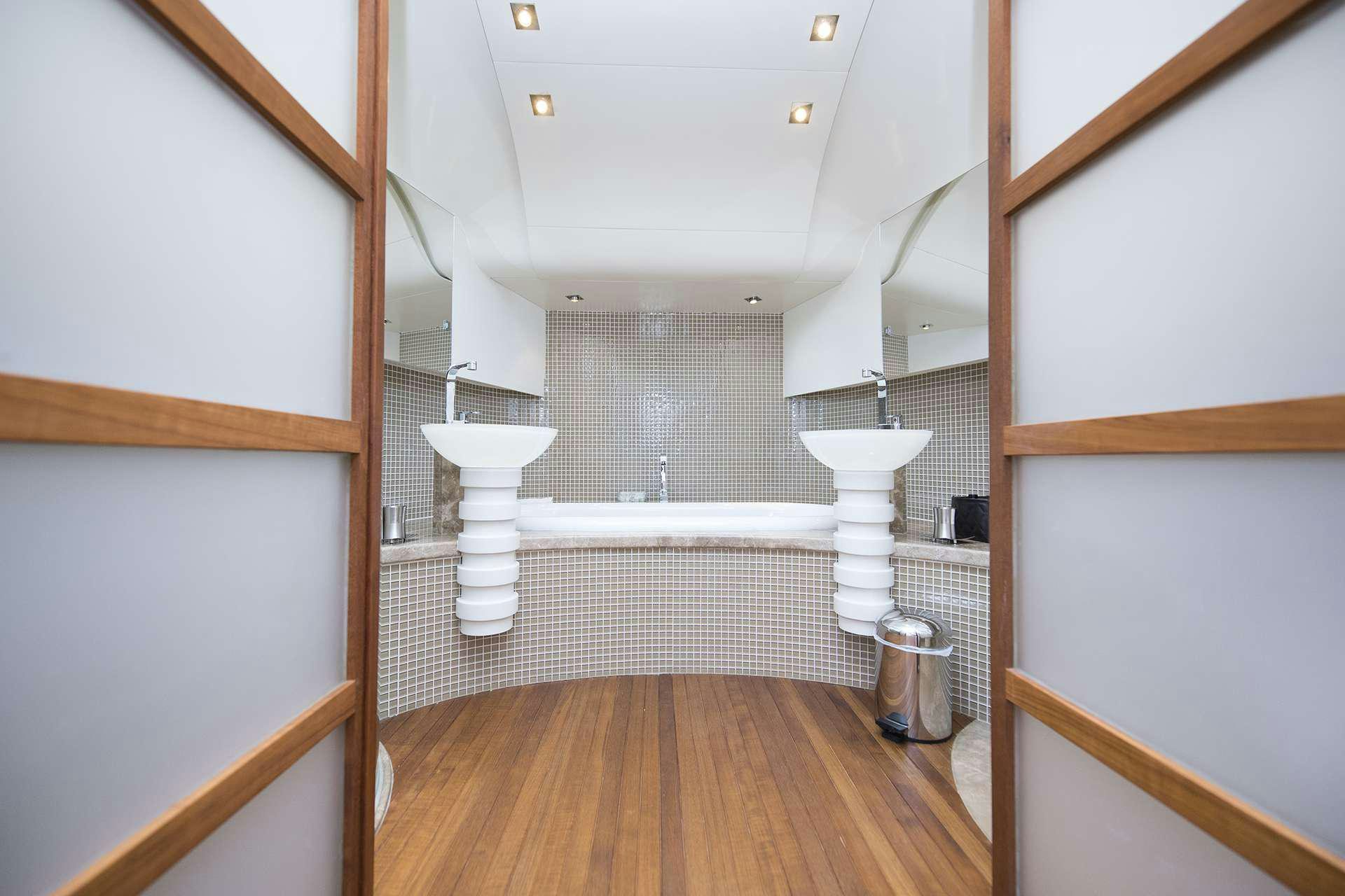 a bathroom with a tub sink and toilet aboard ONE BLUE Yacht for Charter