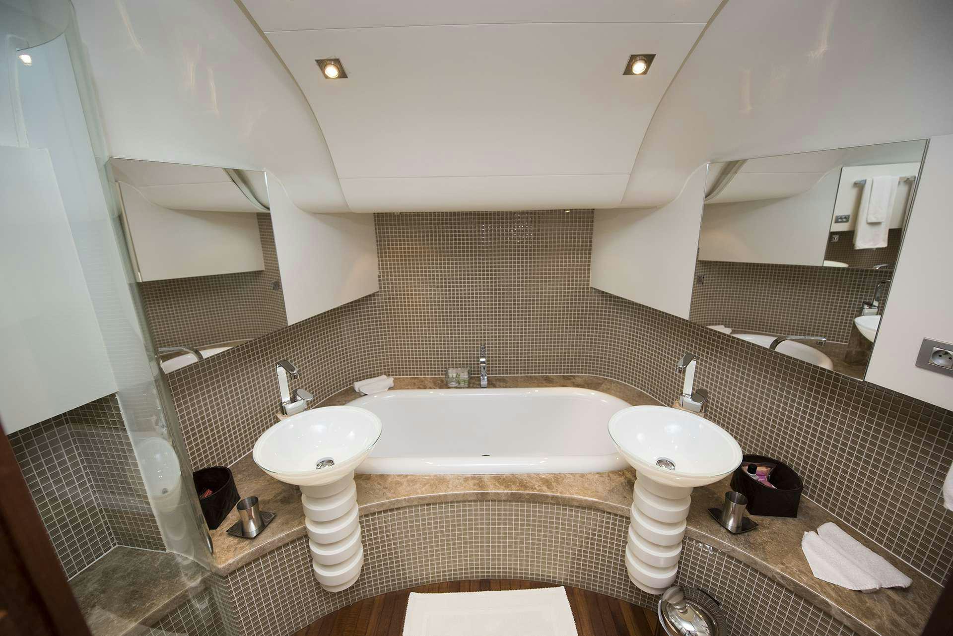 a bathroom with two sinks and a large mirror aboard ONE BLUE Yacht for Charter