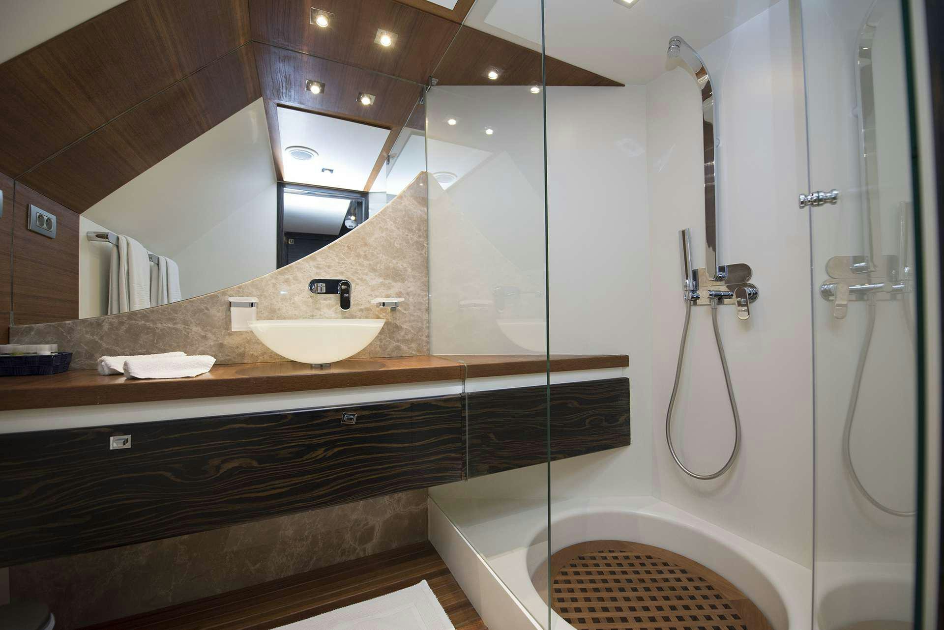 a bathroom with a large mirror aboard ONE BLUE Yacht for Charter