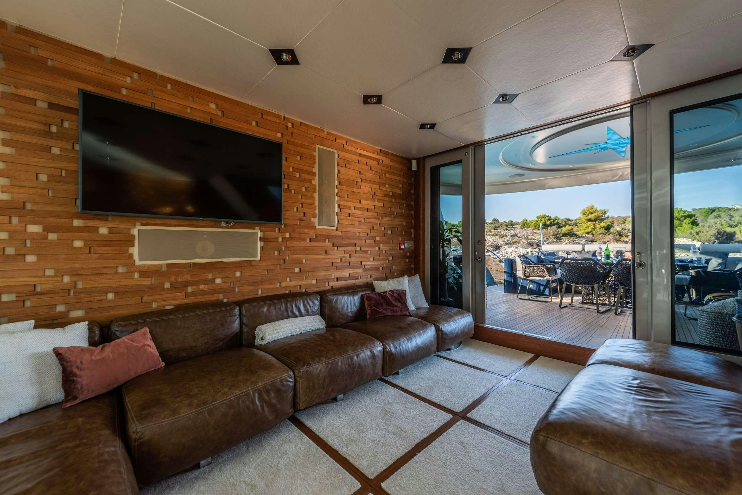 a living room with a wood wall aboard ONE BLUE Yacht for Charter