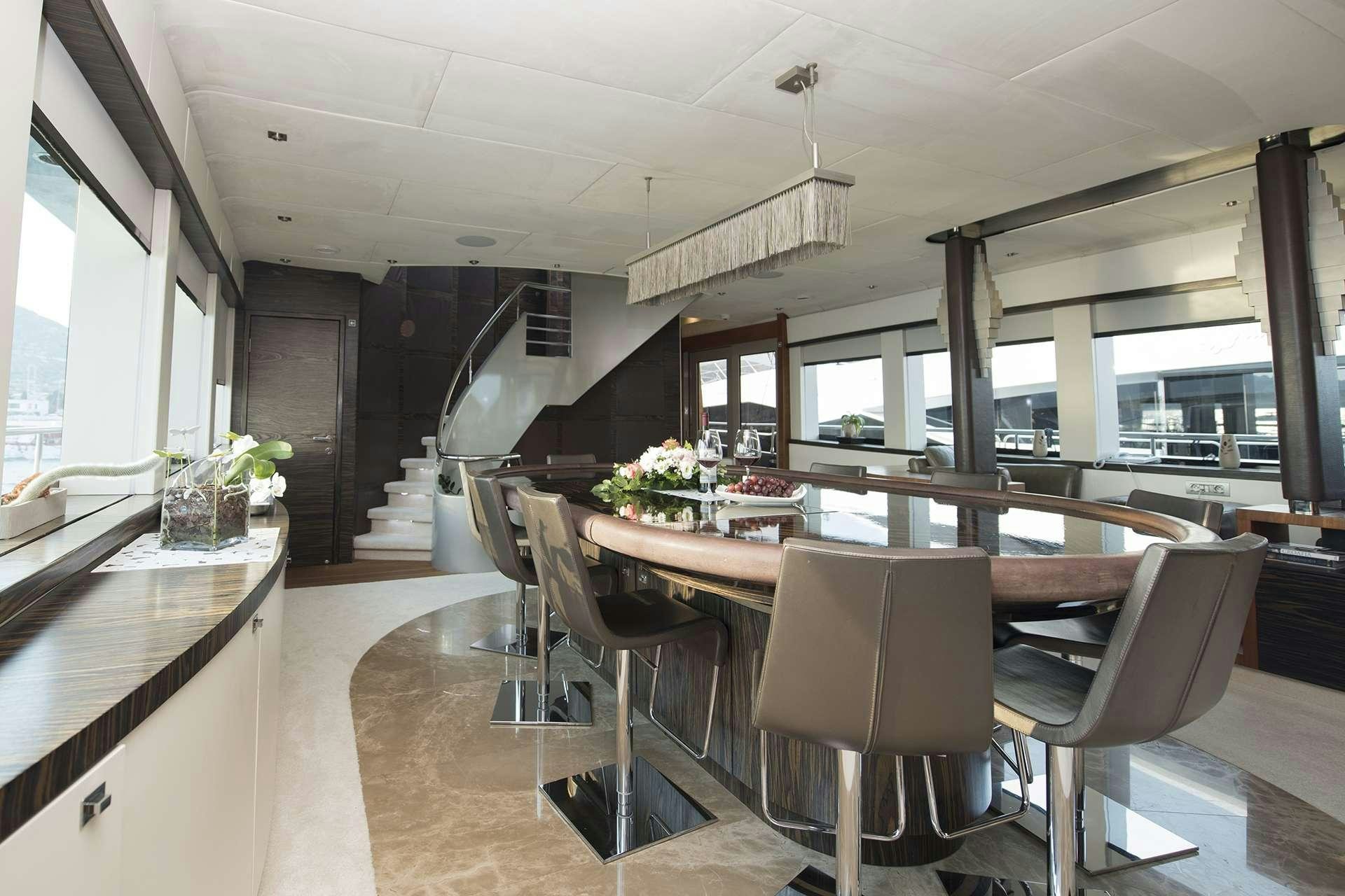 a large kitchen with a dining table aboard ONE BLUE Yacht for Charter