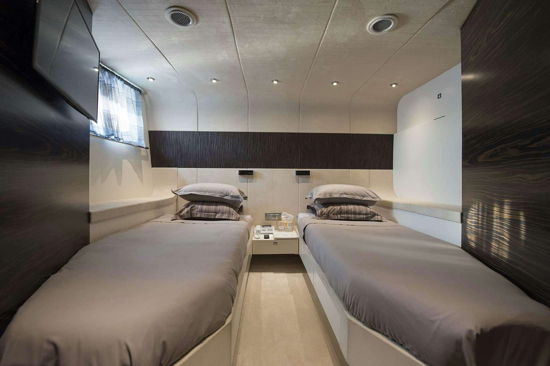 a room with two beds aboard ONE BLUE Yacht for Charter