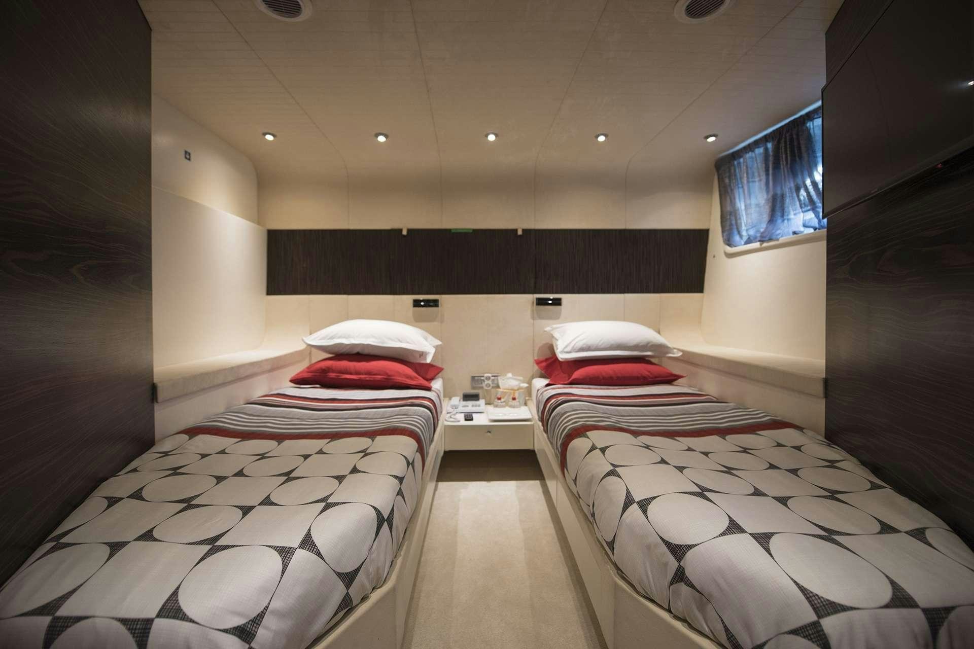 a room with three beds aboard ONE BLUE Yacht for Charter