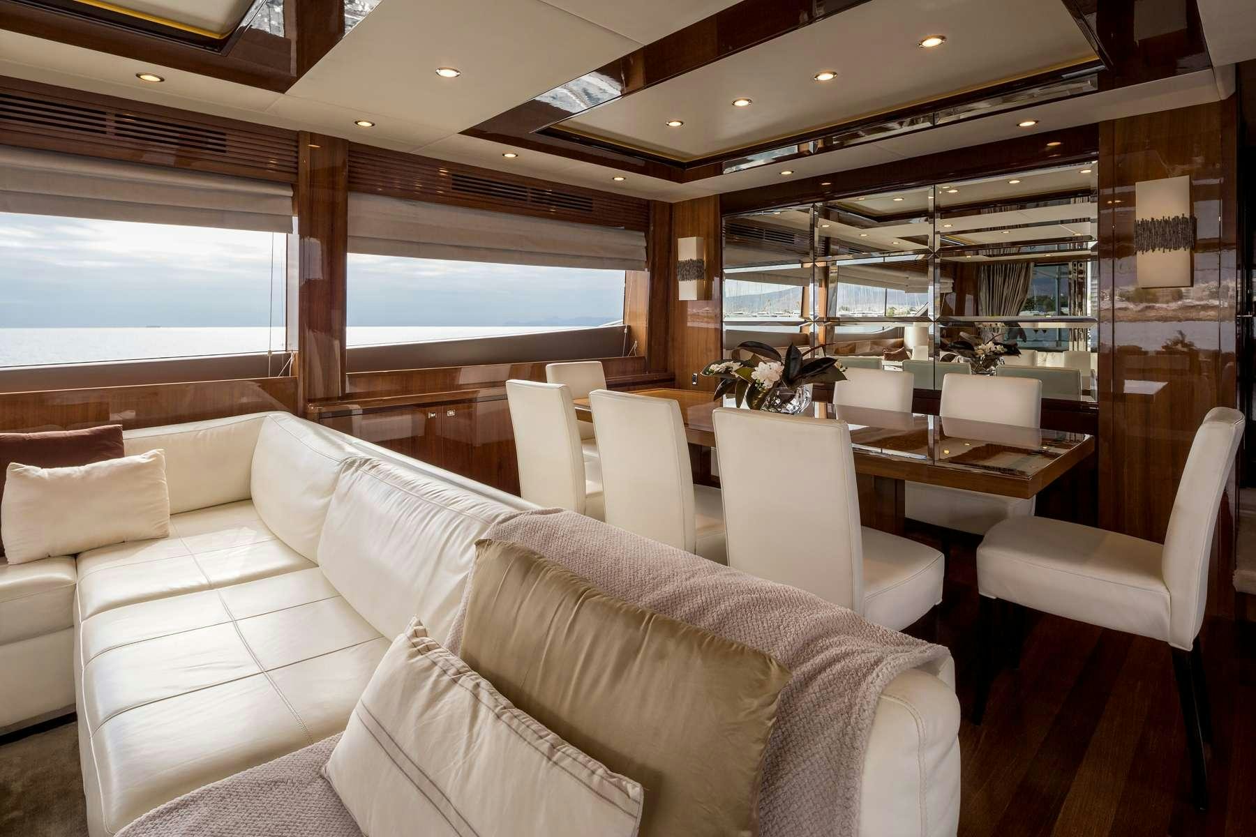 a room with a couch and a table and chairs aboard 4LIFE Yacht for Charter