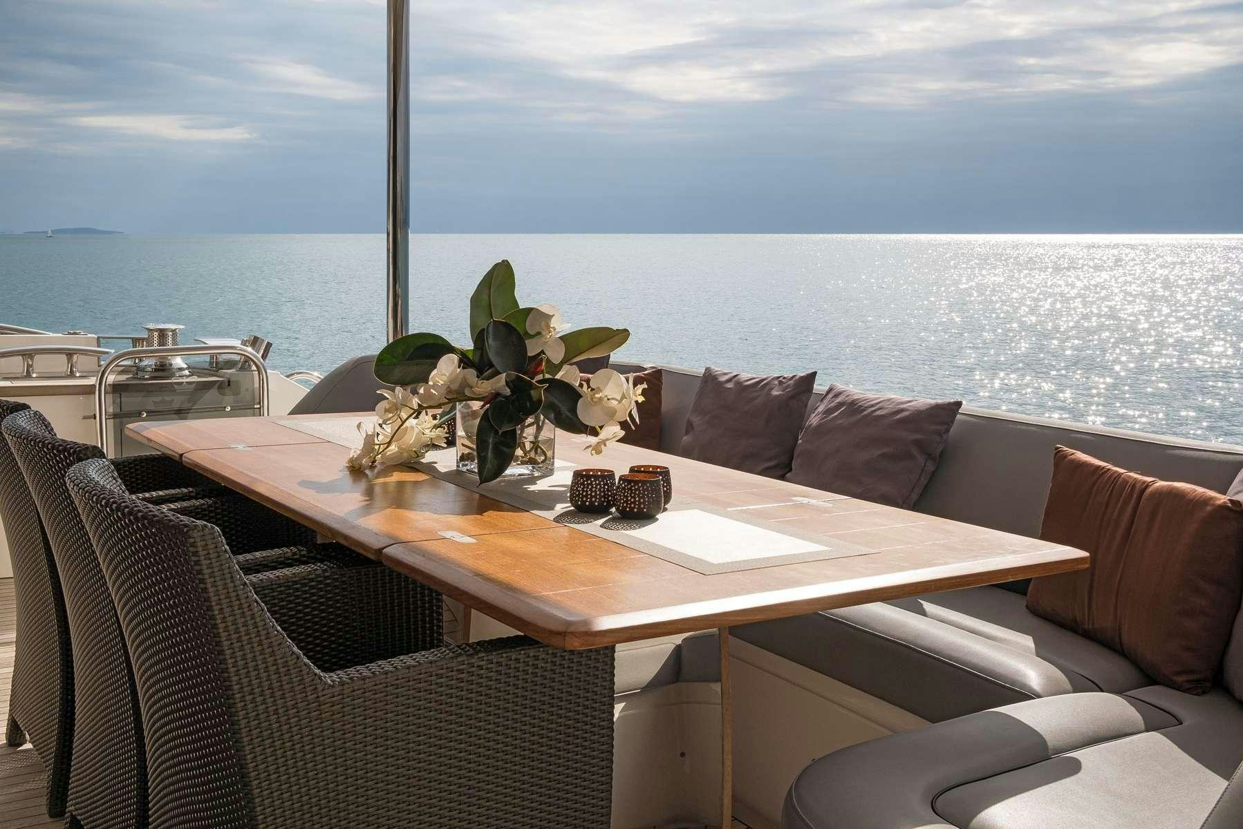 a table with chairs and plants on it aboard 4LIFE Yacht for Charter