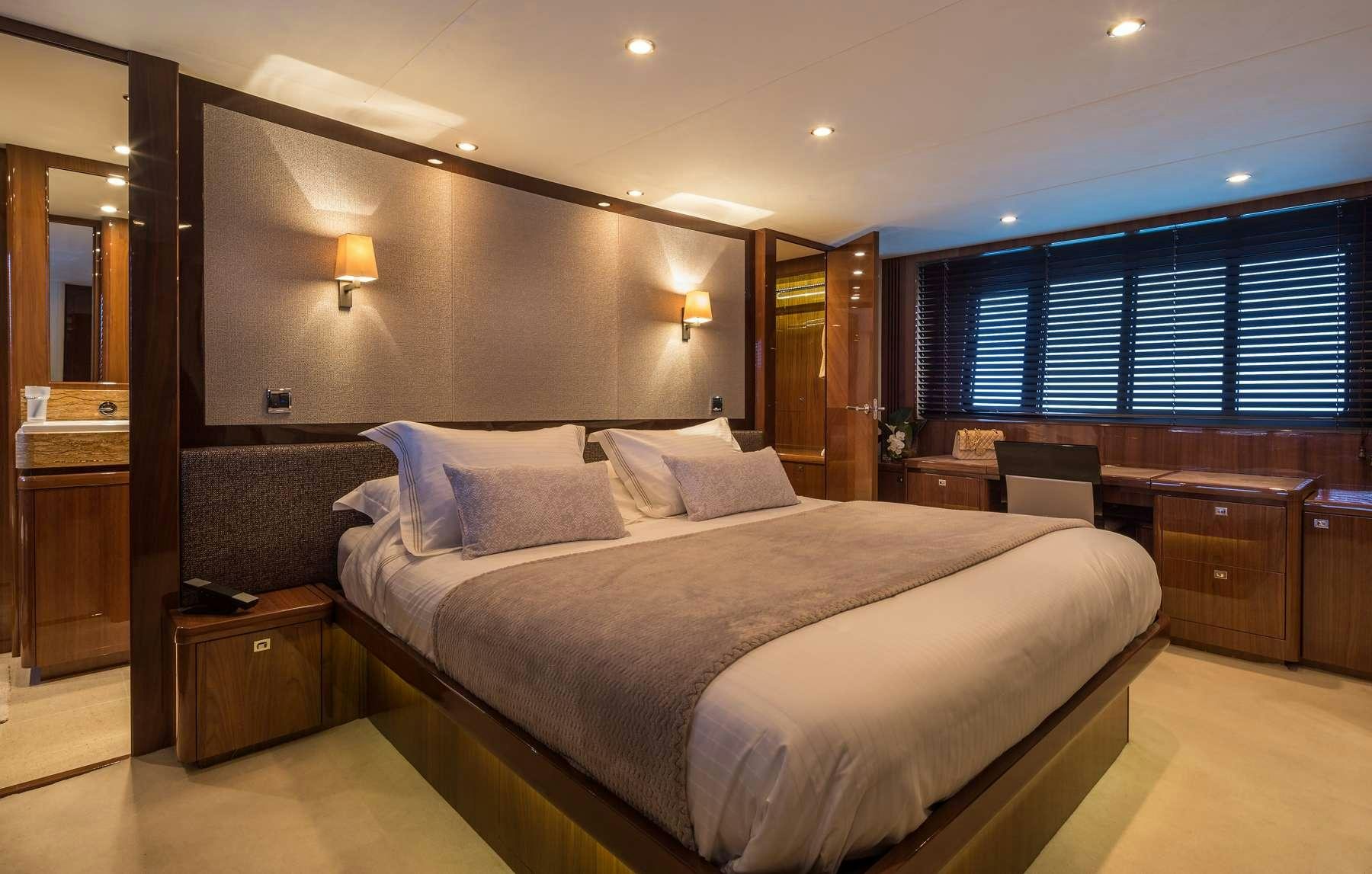 a large bed in a hotel room aboard 4LIFE Yacht for Charter