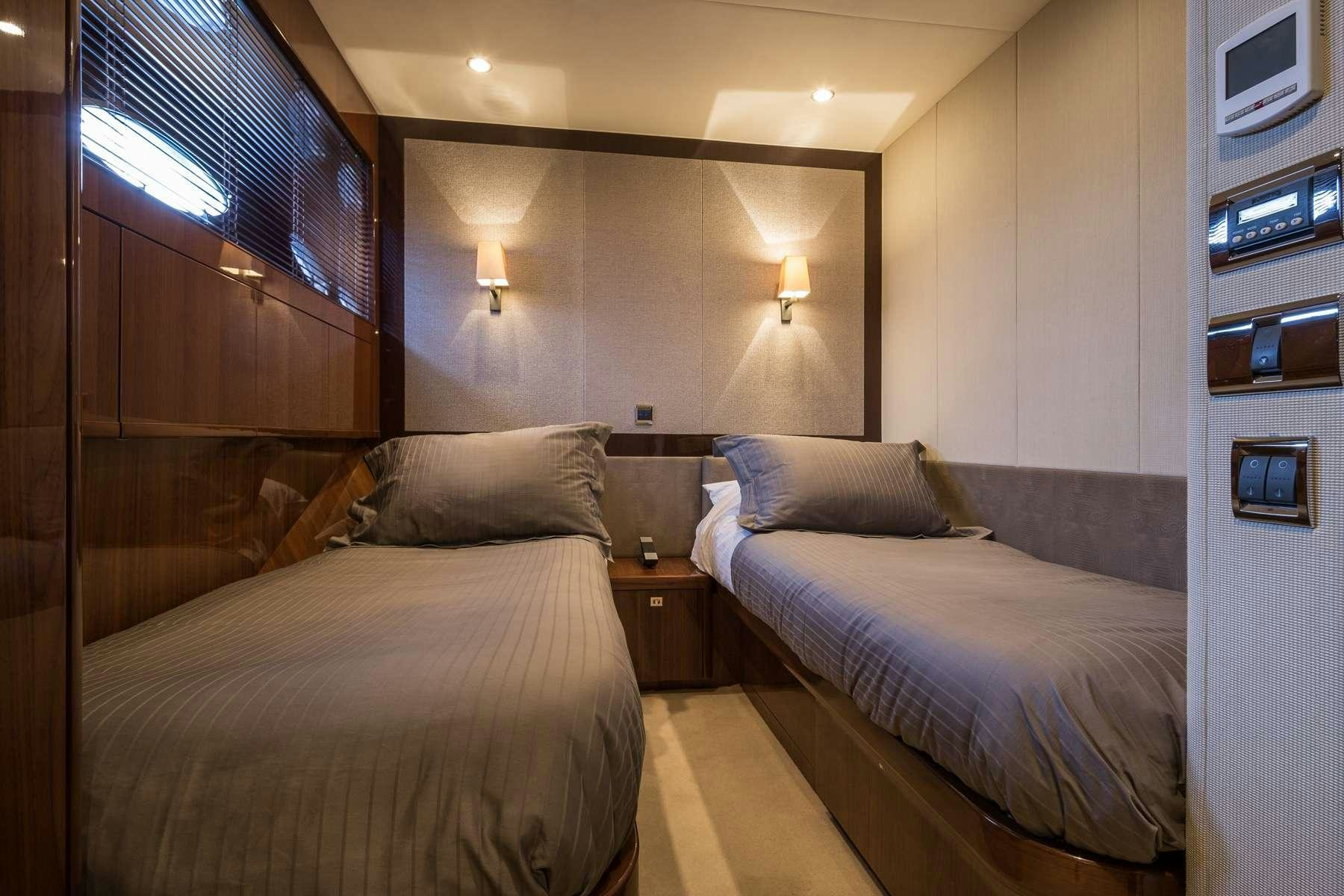 a room with two beds aboard 4LIFE Yacht for Charter