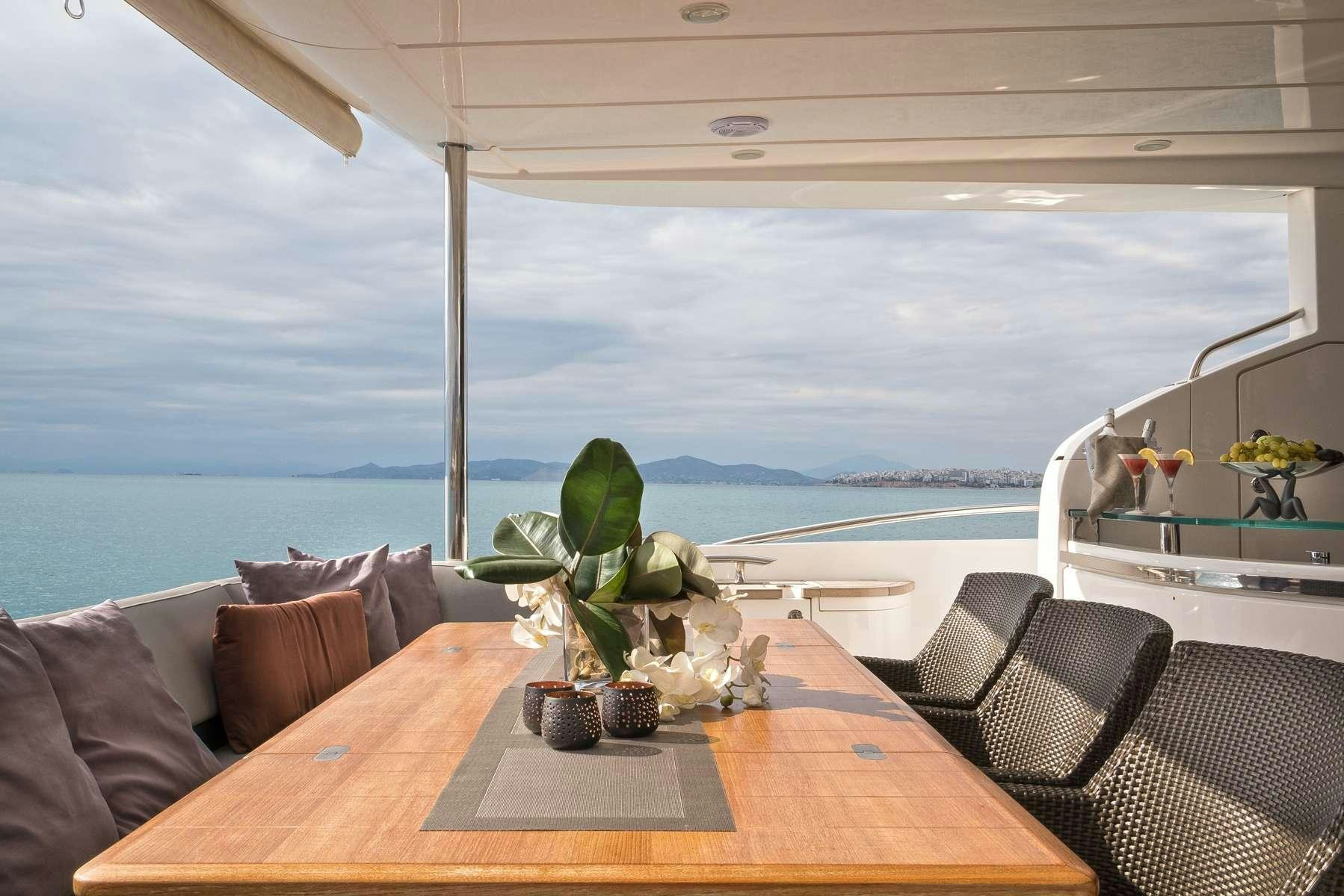 a table with chairs and plants on it aboard 4LIFE Yacht for Charter