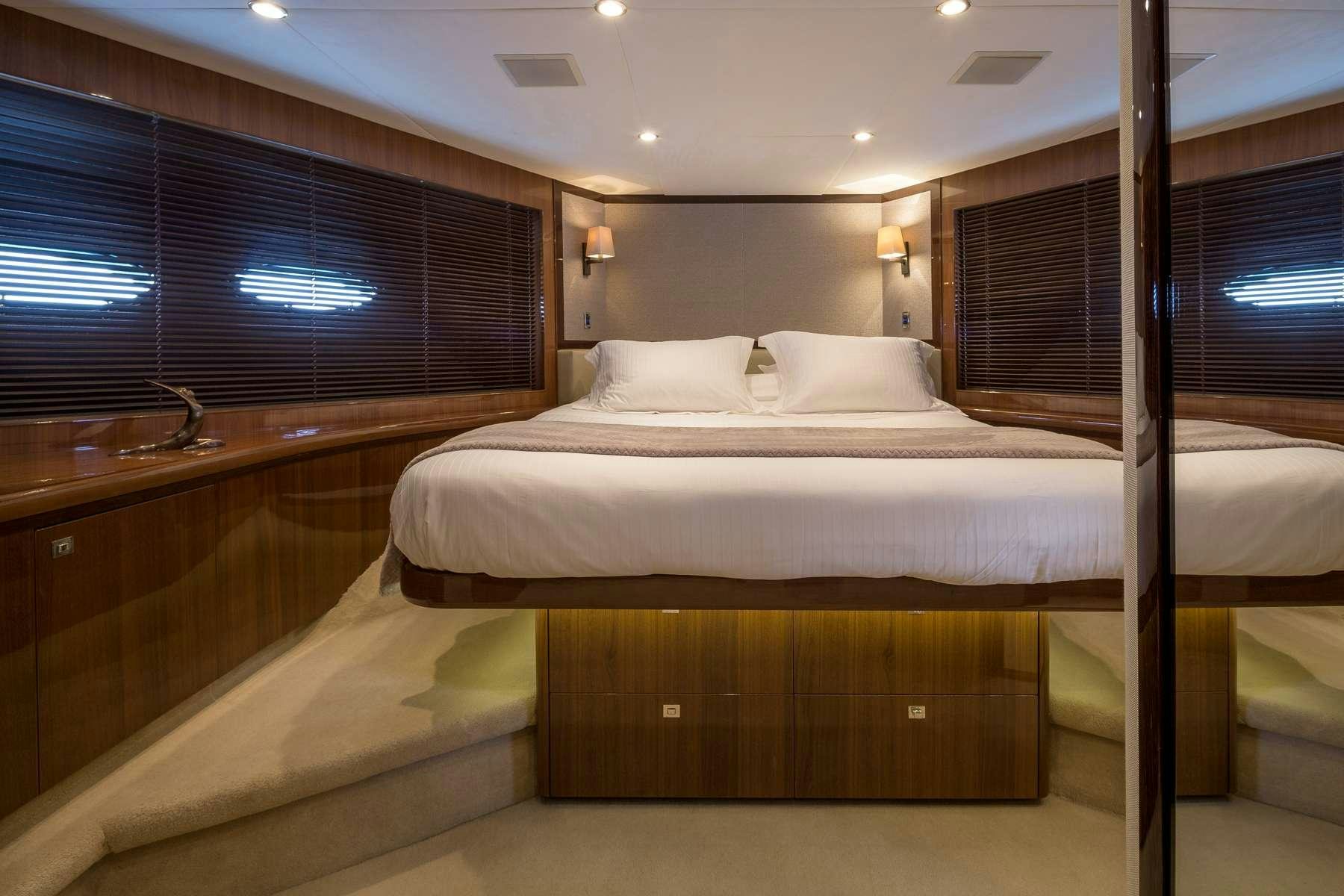 a room with a bed and a window aboard 4LIFE Yacht for Charter