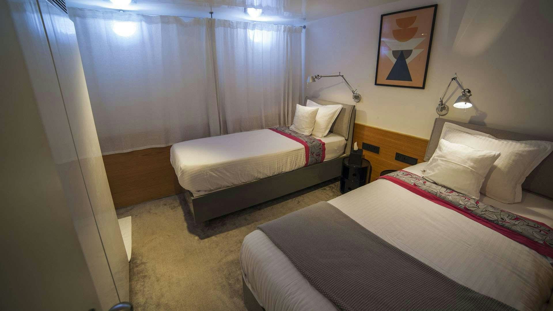 a room with two beds aboard AZALEA Yacht for Charter