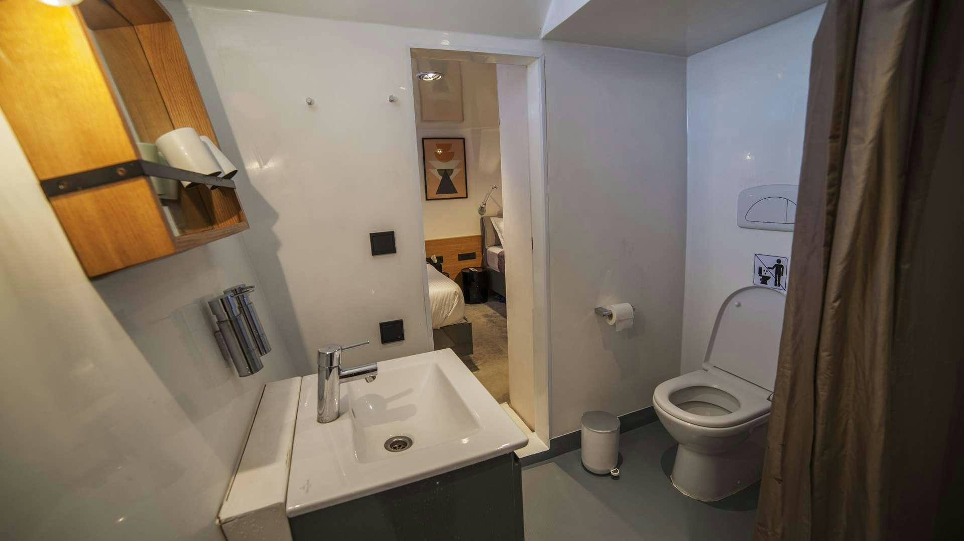 a bathroom with a sink and a toilet aboard AZALEA Yacht for Charter