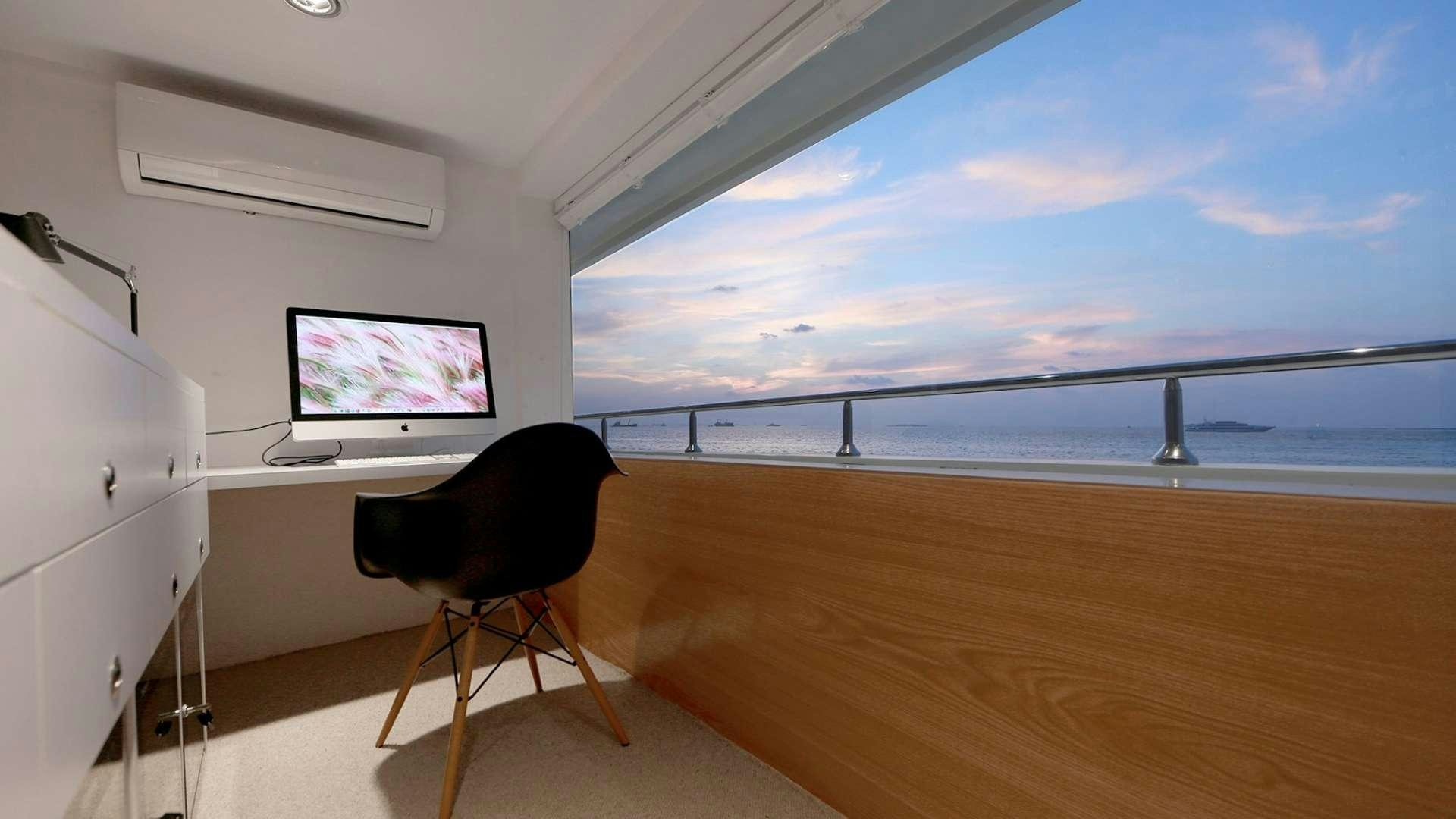 a room with a tv and a chair aboard AZALEA Yacht for Charter