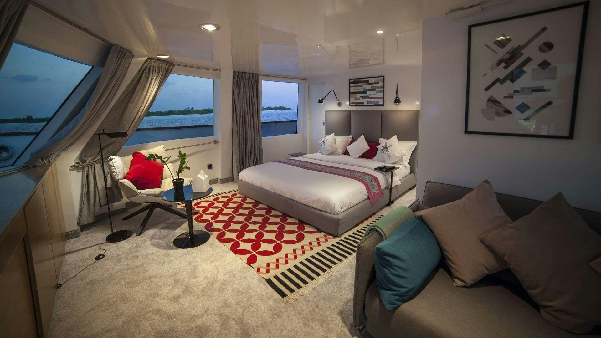 a bedroom with a bed and a tv aboard AZALEA Yacht for Charter