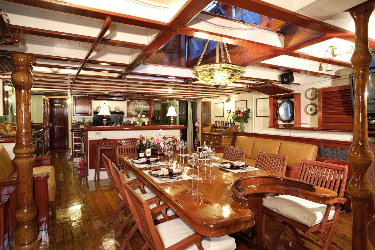 a dining room with a table and chairs aboard PACIFIC YELLOWFIN Yacht for Charter