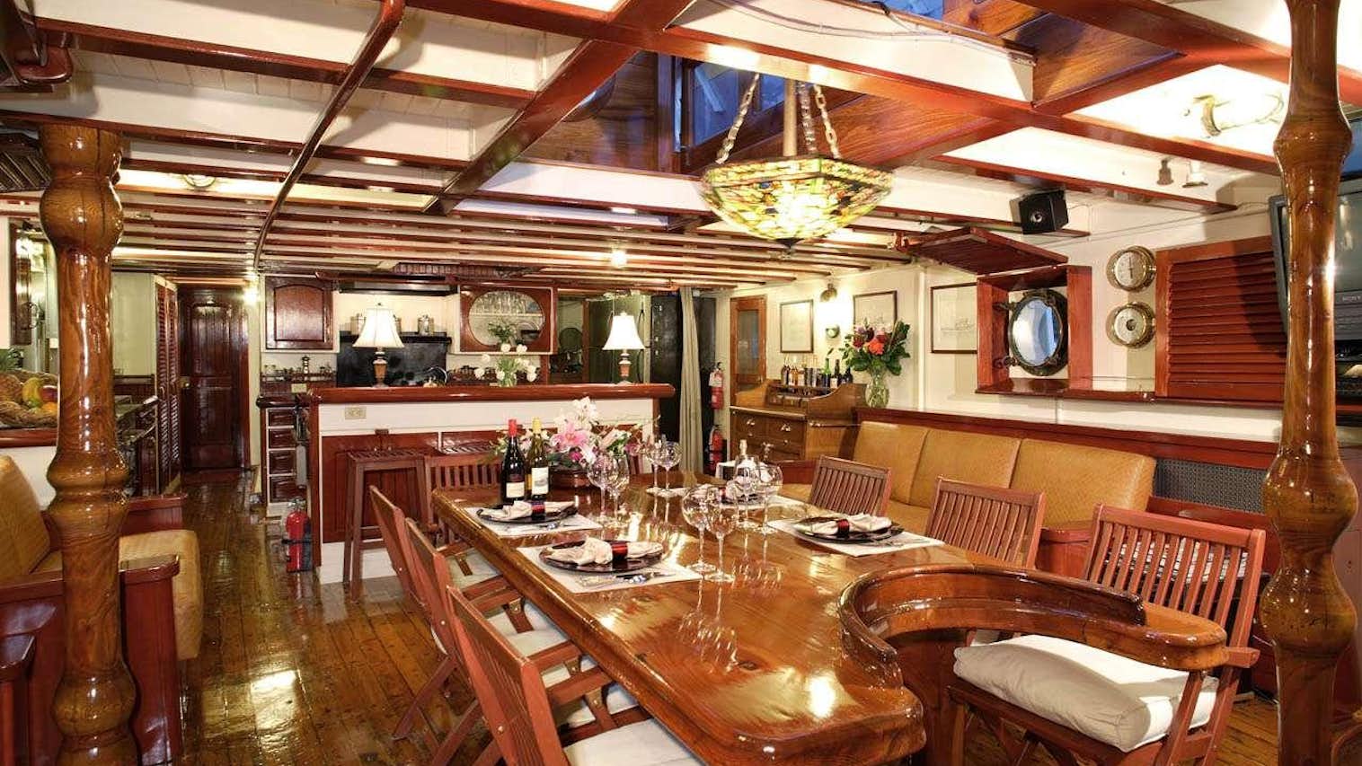a dining room with a table and chairs aboard PACIFIC YELLOWFIN Yacht for Charter