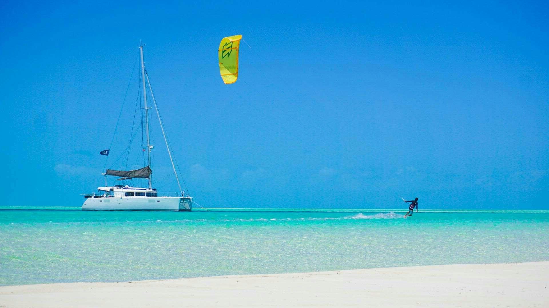 a person kite surfing on the sea aboard Madrigal V Yacht for Charter