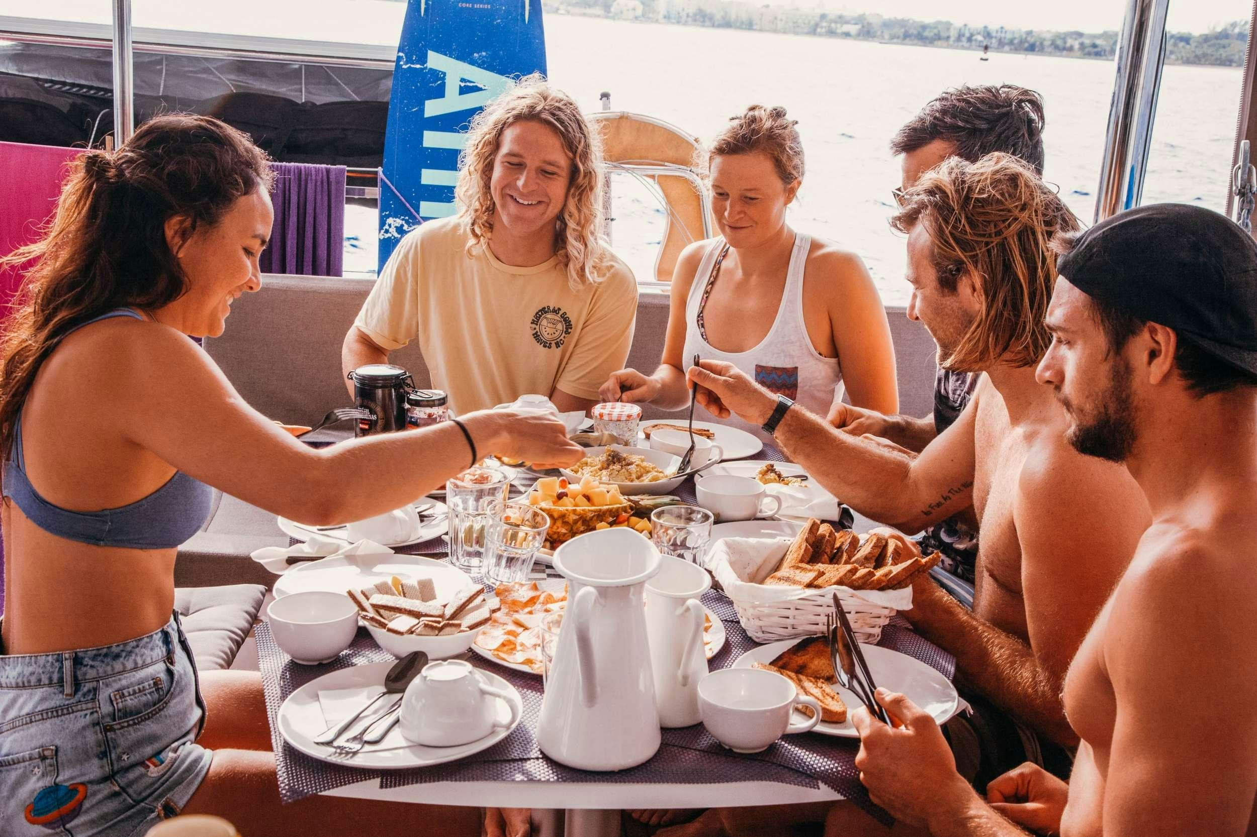 a group of women eating at a table aboard Madrigal V Yacht for Charter