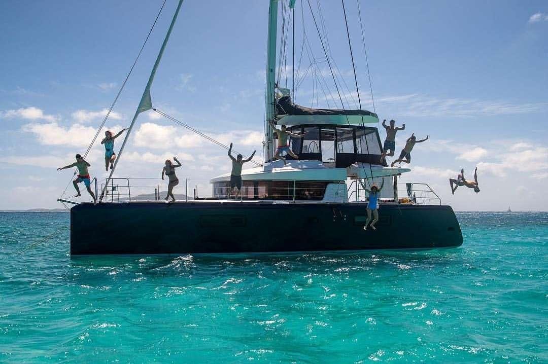 a boat with people jumping off the water aboard VENTANA Yacht for Charter