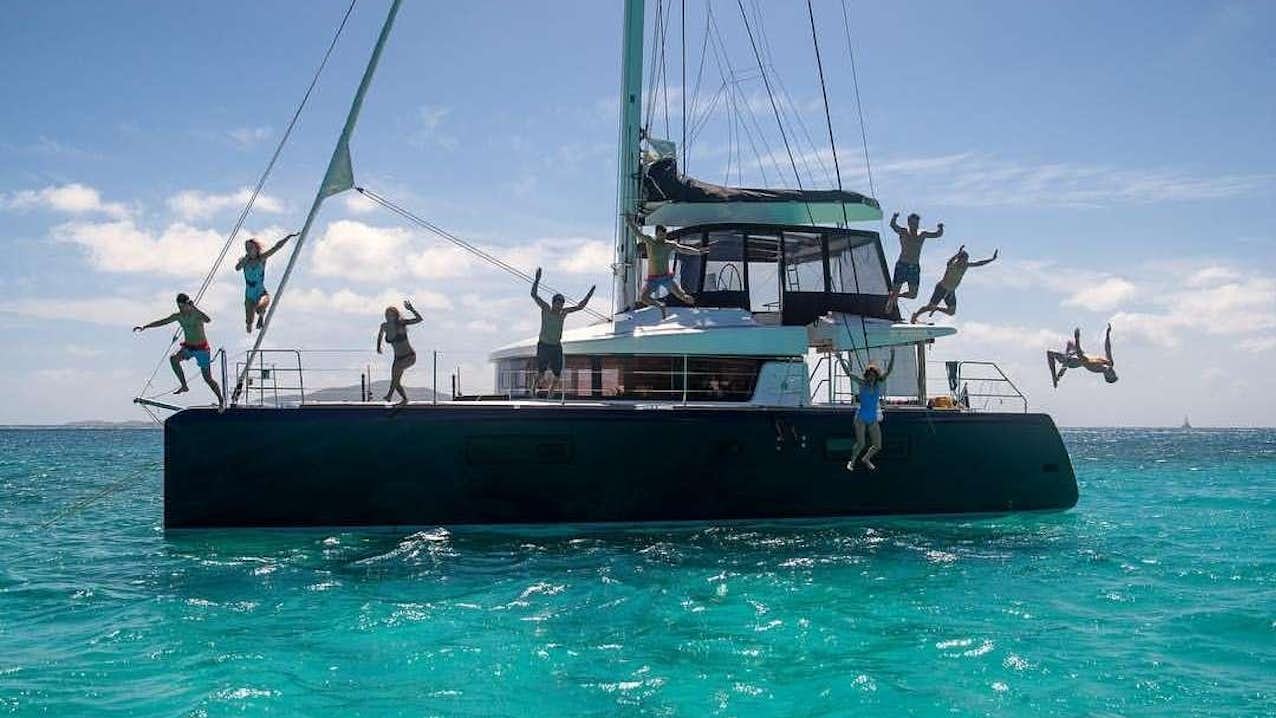 a boat with people jumping off the water aboard VENTANA Yacht for Charter
