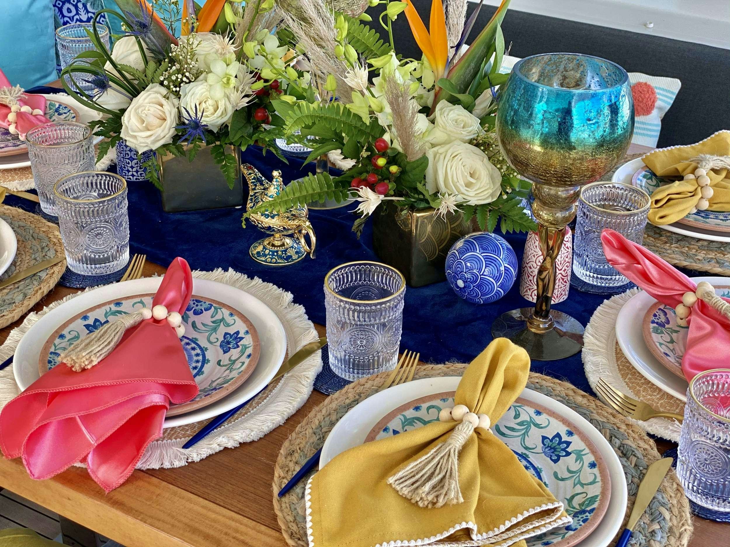 a table with plates and glasses aboard VENTANA Yacht for Charter