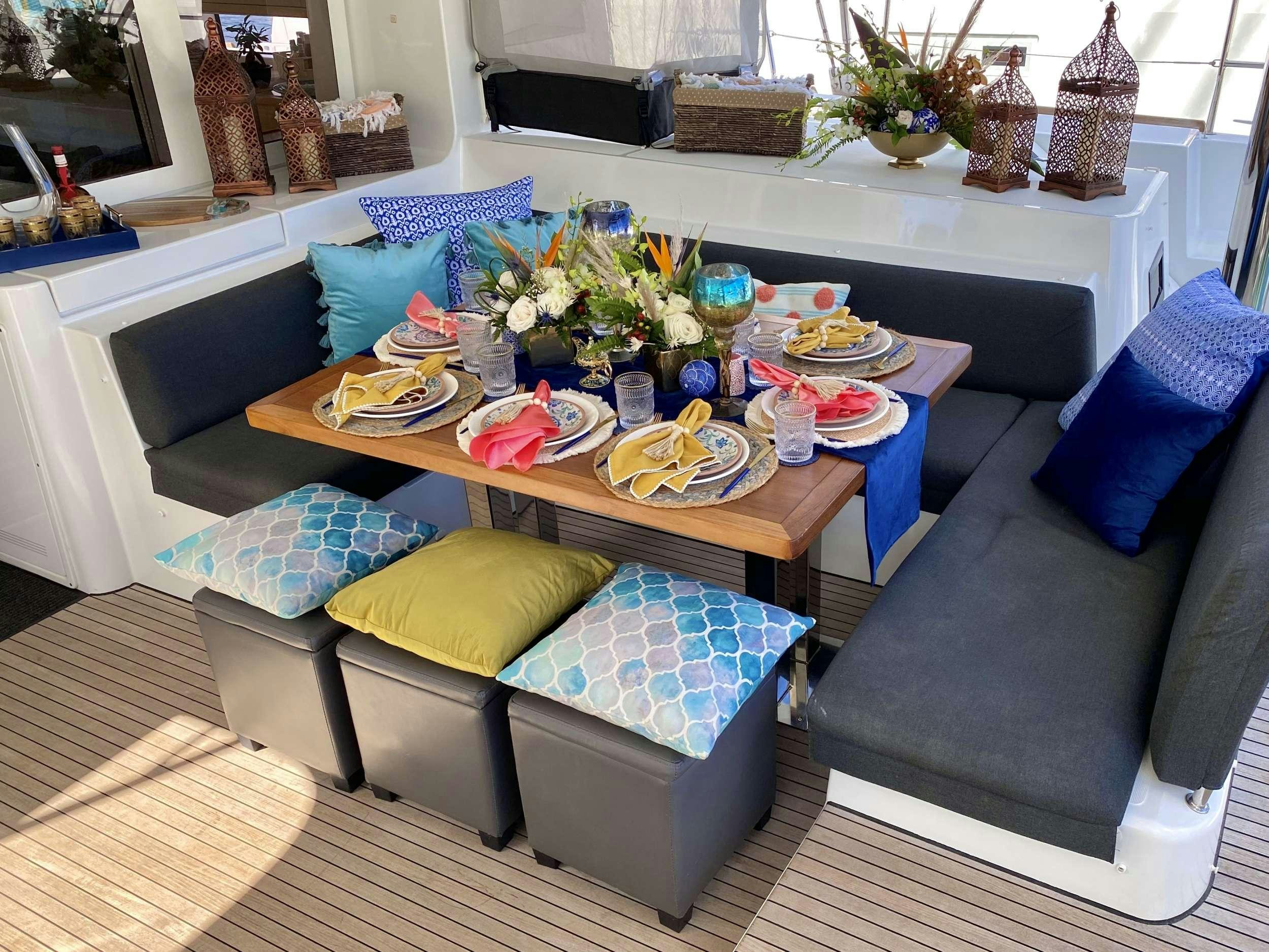 a living room with a table and couches aboard VENTANA Yacht for Charter