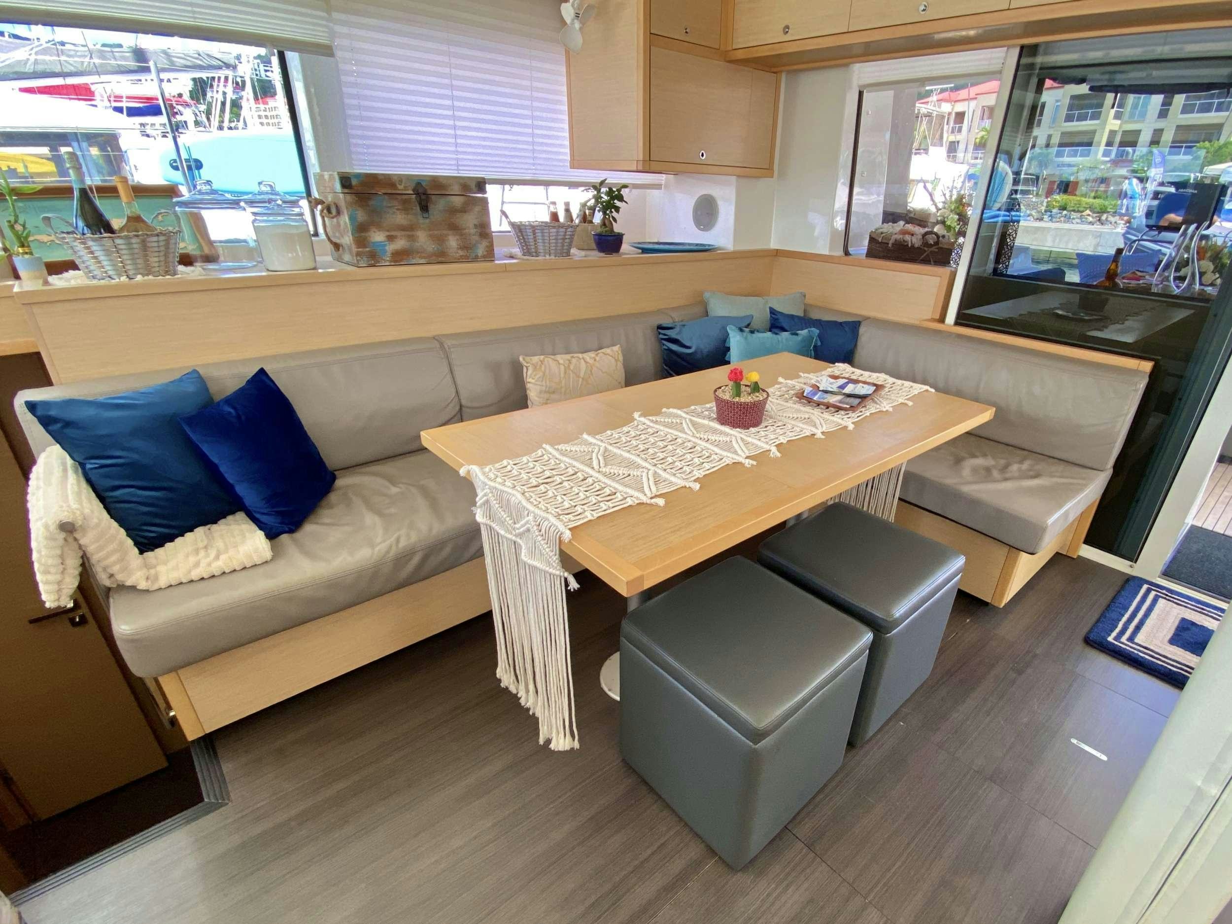 a living room with a couch and a table aboard VENTANA Yacht for Charter