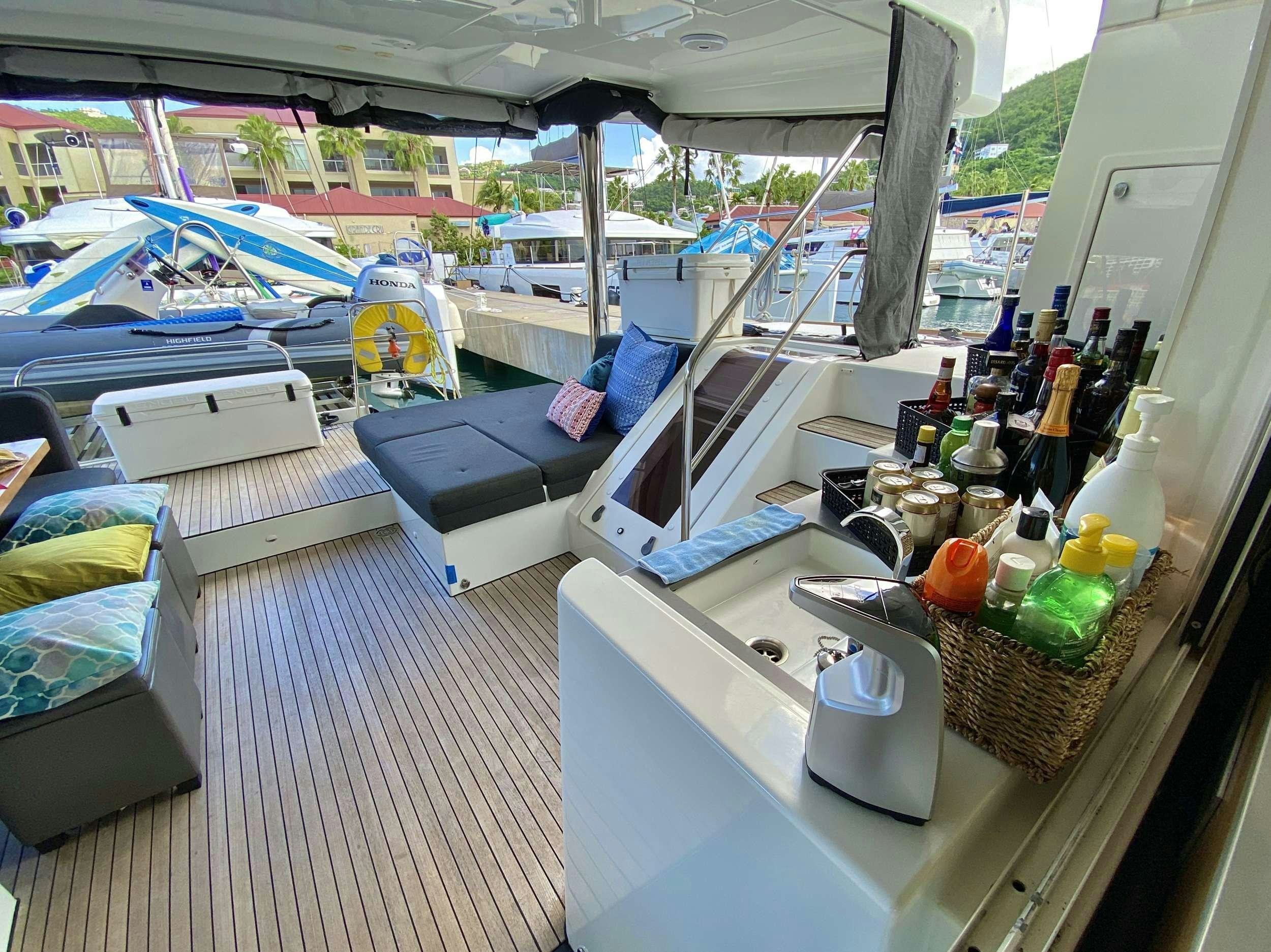 a boat house with a boat and a table full of bottles aboard VENTANA Yacht for Charter