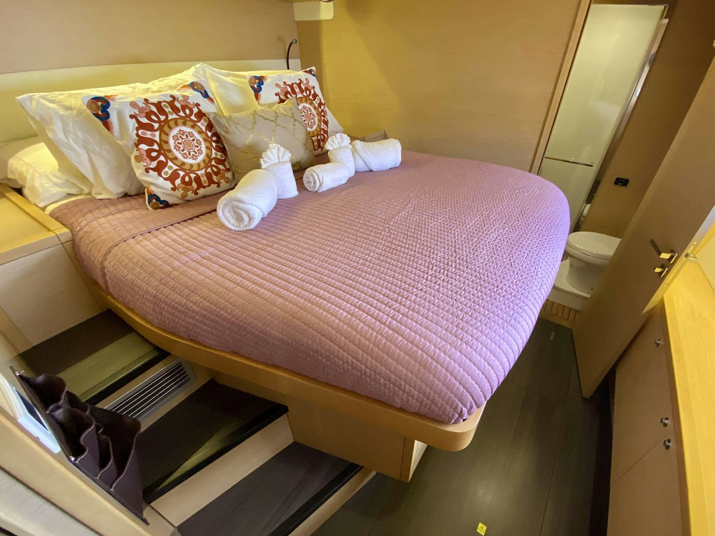 a cat lying on a bed aboard VENTANA Yacht for Charter