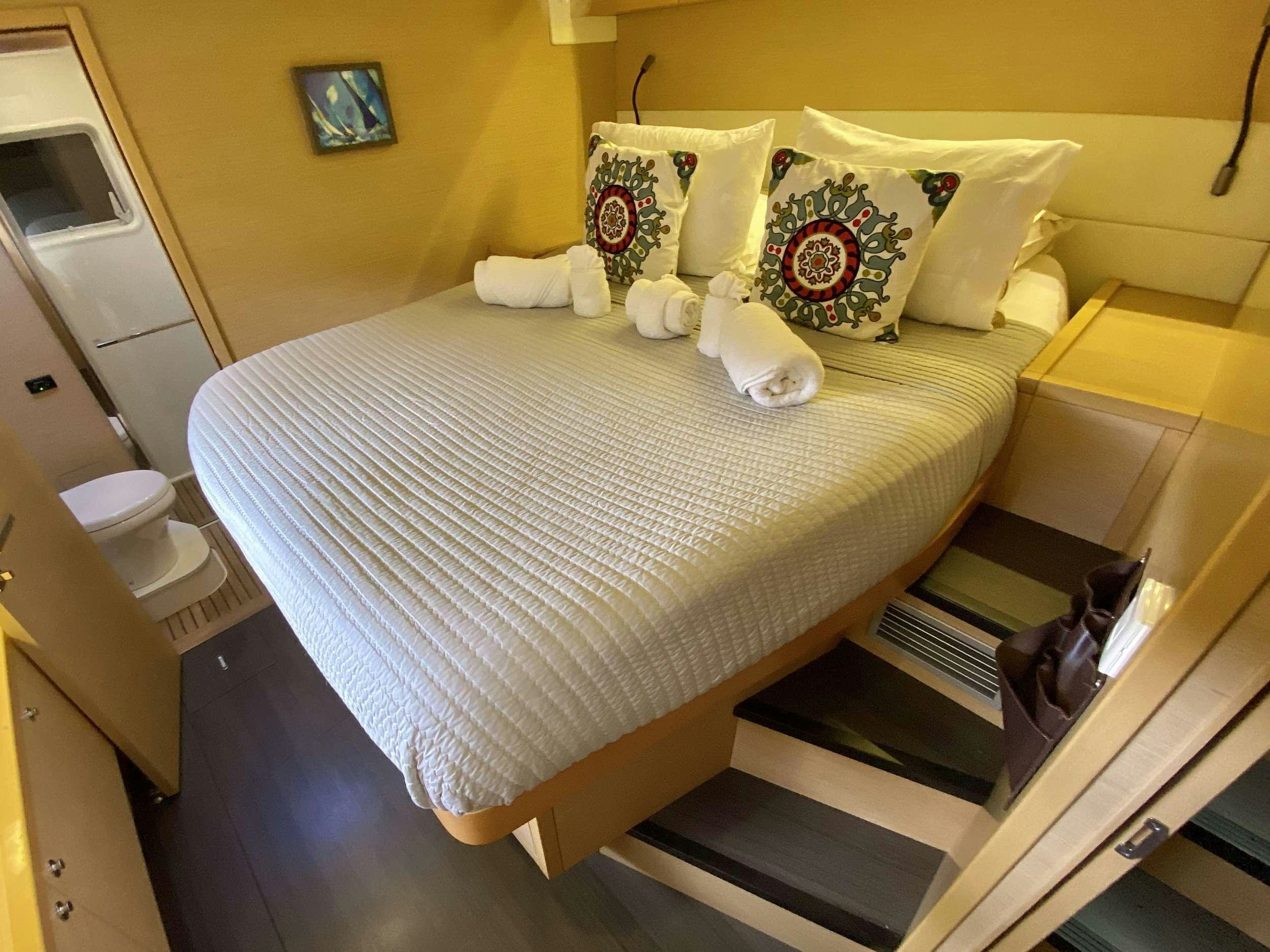 a bed with white pillows aboard VENTANA Yacht for Charter