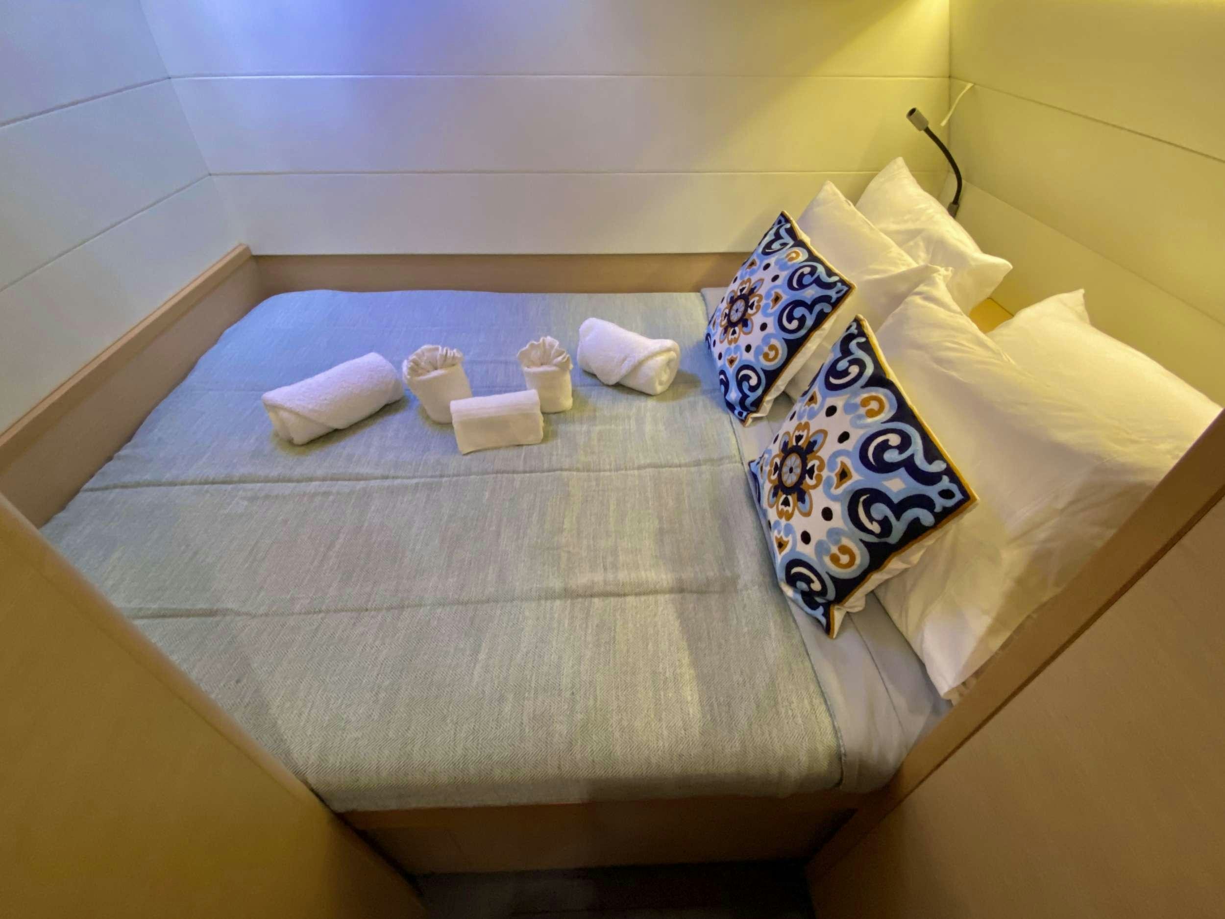 a bed with pillows and pillows aboard VENTANA Yacht for Charter