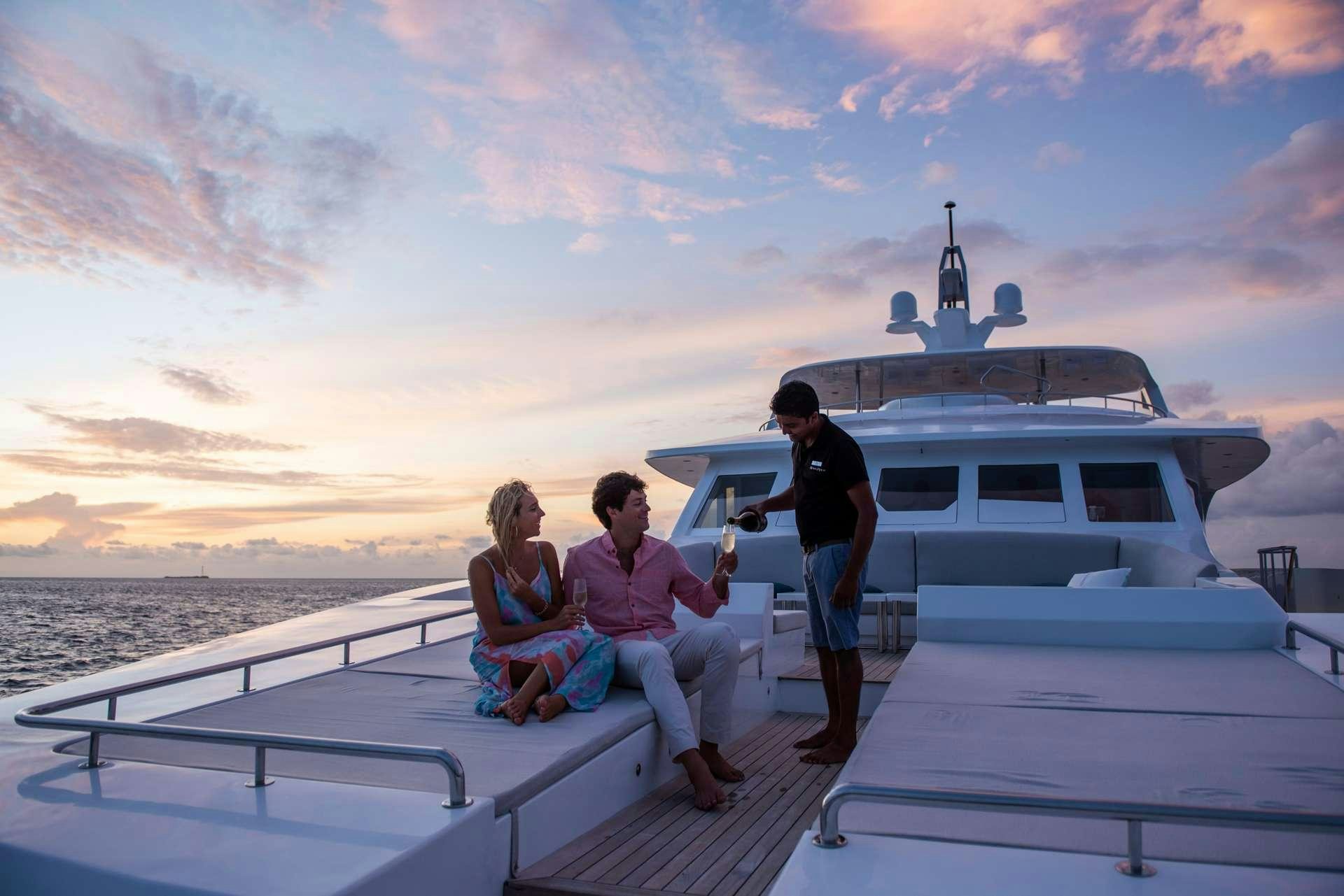 a group of people sitting on a dock on a boat aboard SEAREX Yacht for Charter