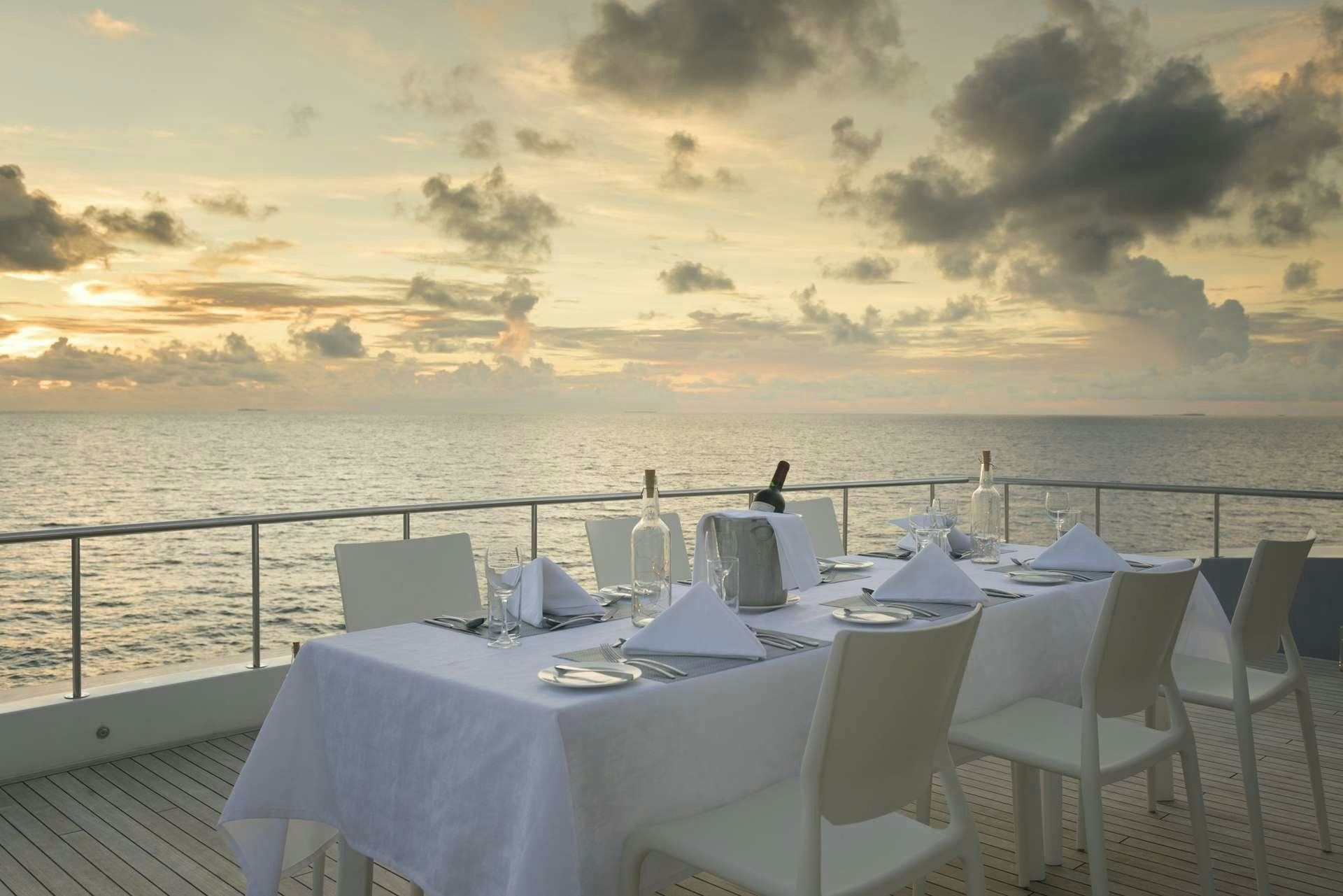 a table set for a dinner on a boat aboard SEAREX Yacht for Charter