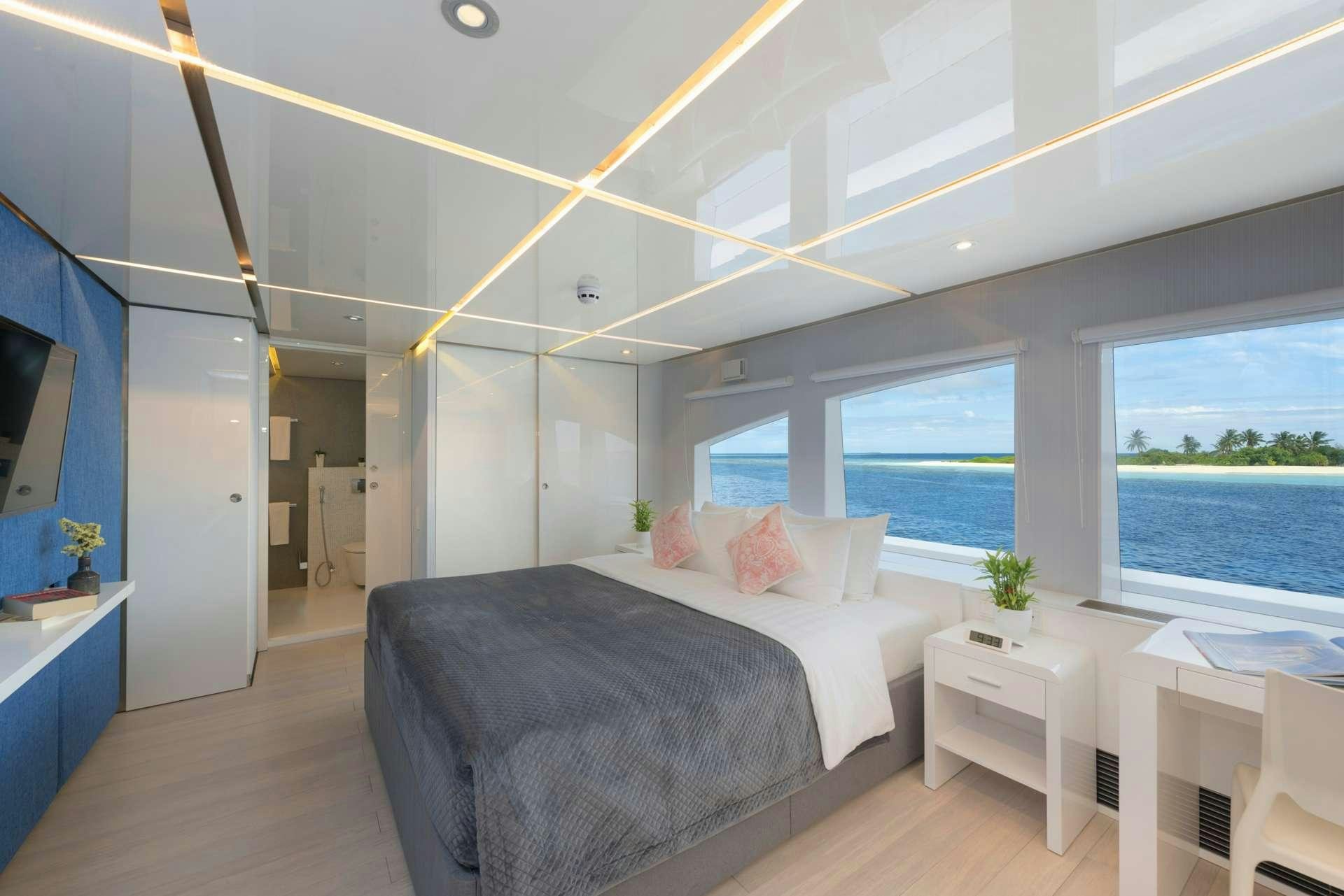 a bedroom with a large bed aboard SEAREX Yacht for Charter