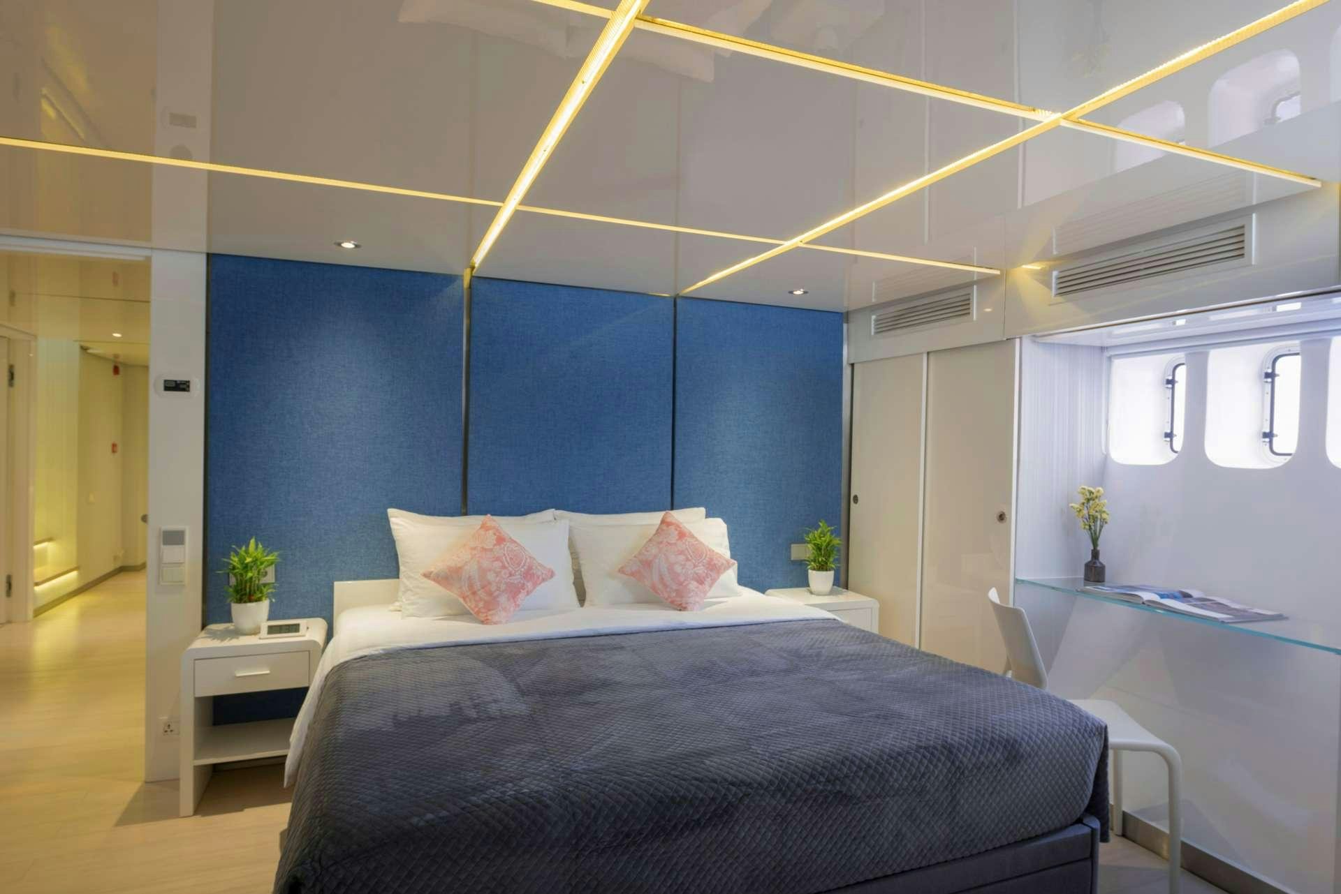 a bedroom with blue walls aboard SEAREX Yacht for Charter