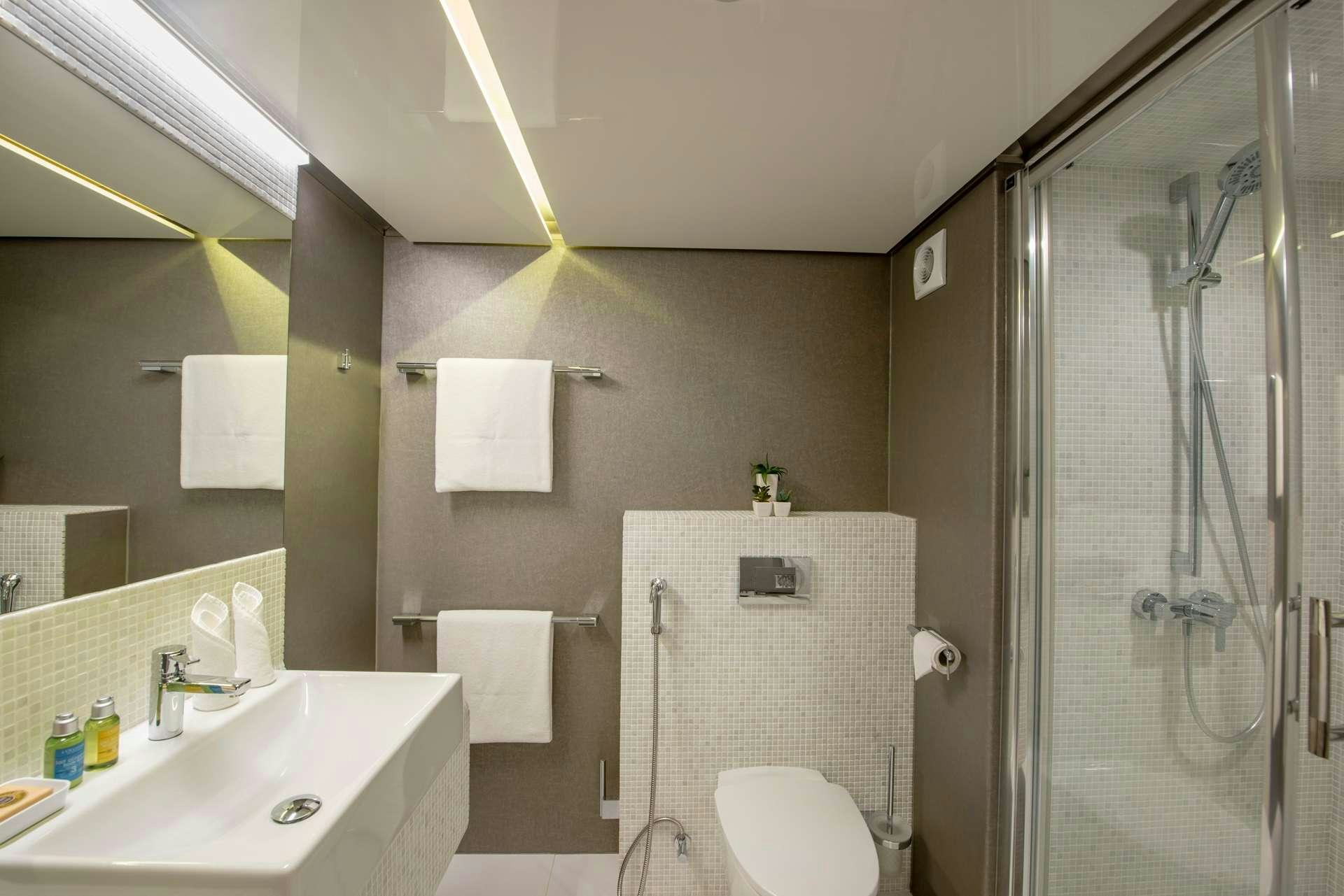 a bathroom with a glass shower aboard SEAREX Yacht for Charter