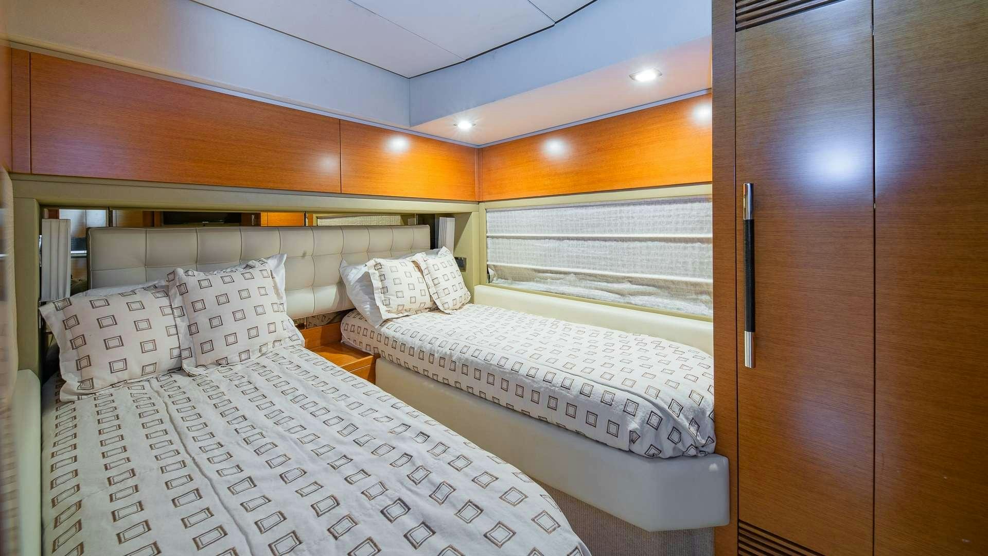 a room with beds and a window aboard WICKED Yacht for Charter