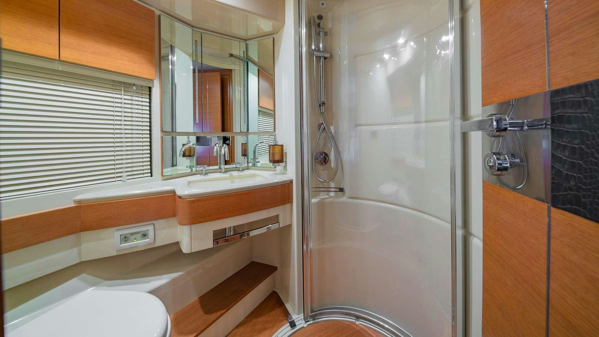 a bathroom with a tub sink and toilet aboard WICKED Yacht for Charter