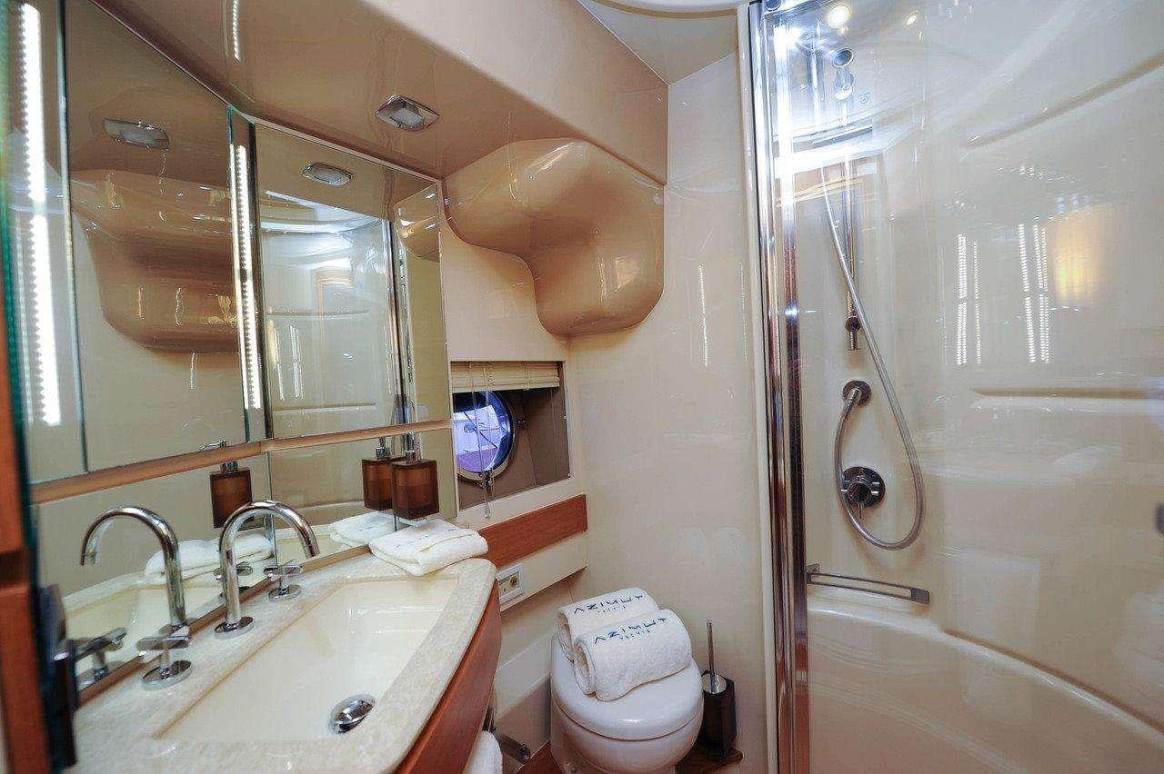 a bathroom with a toilet and sink aboard WICKED Yacht for Charter