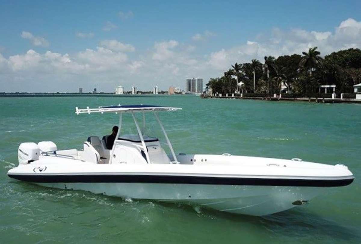 a white boat in the water aboard WICKED Yacht for Charter