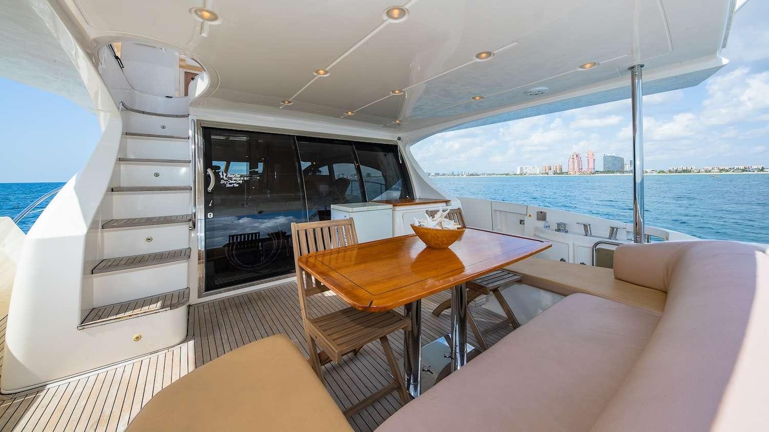 a boat with a table and chairs aboard WICKED Yacht for Charter