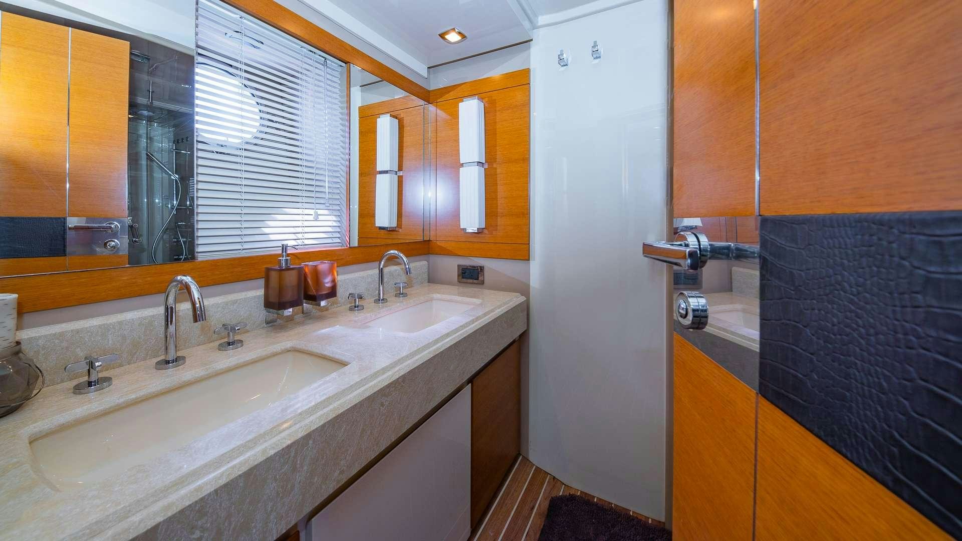 a bathroom with a sink and a mirror aboard WICKED Yacht for Charter