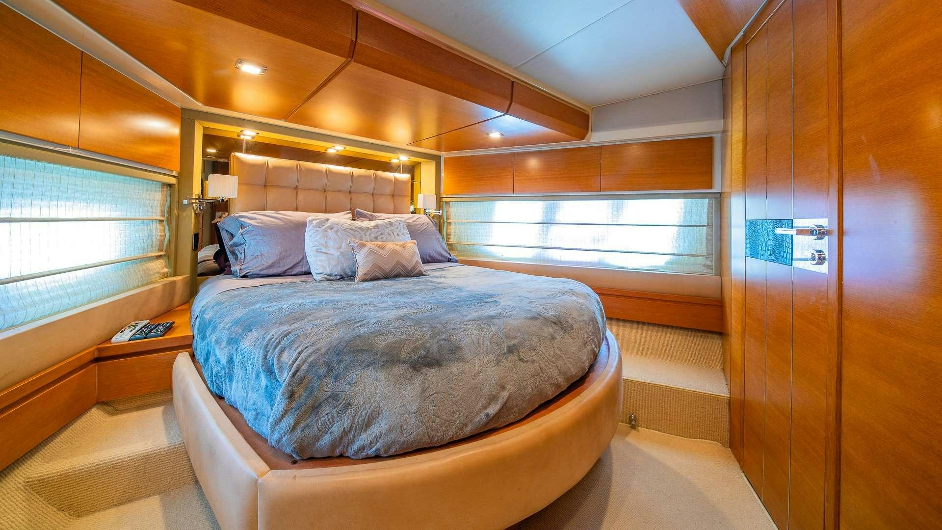 a room with a bed and a window aboard WICKED Yacht for Charter