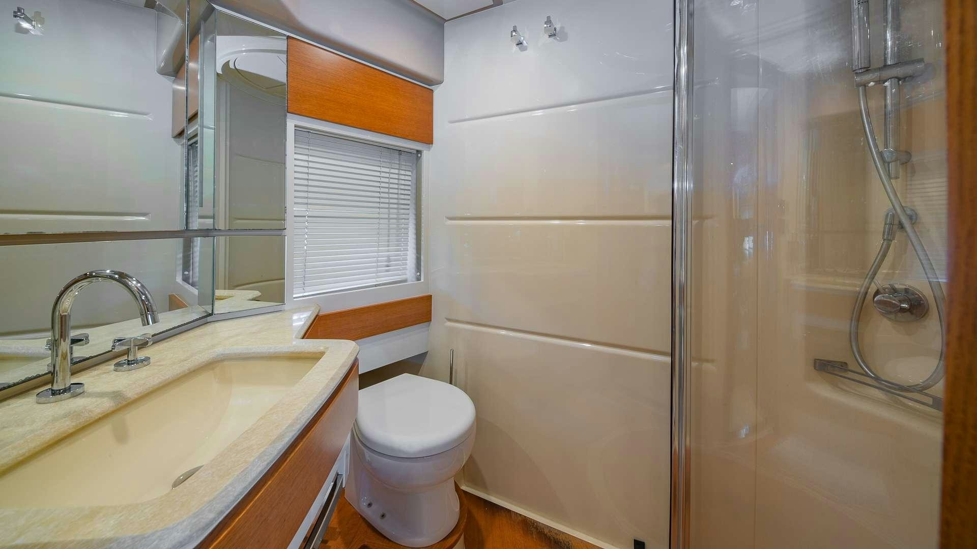a bathroom with a toilet and sink aboard WICKED Yacht for Charter