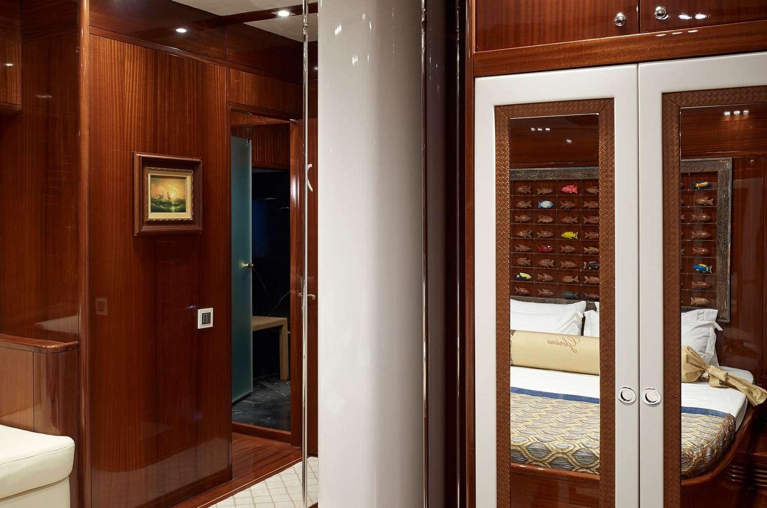 a room with a bed and a mirror aboard G GIRL Yacht for Charter