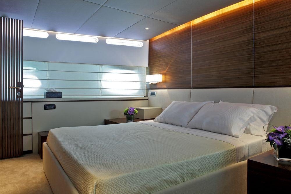 a bed with white sheets aboard TROPICANA Yacht for Charter