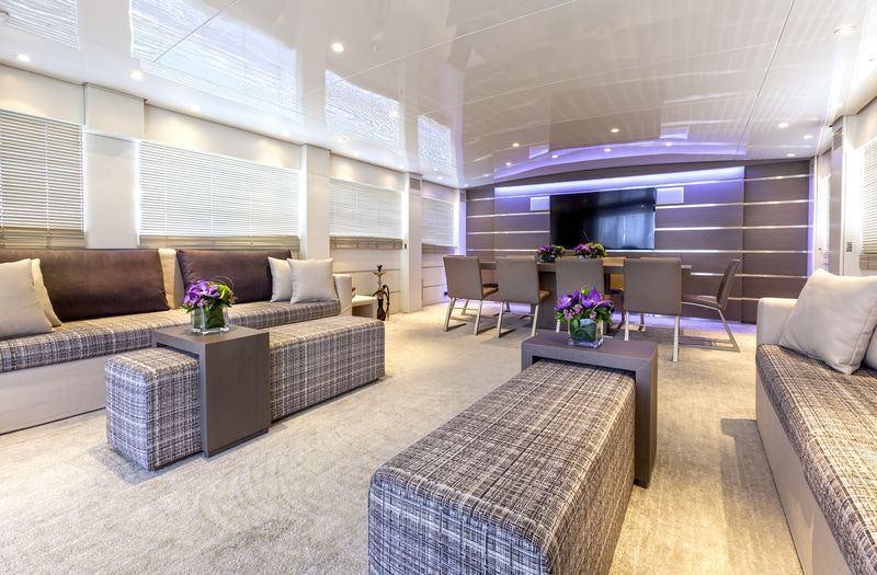 a living room with a couch and a table aboard TROPICANA Yacht for Charter