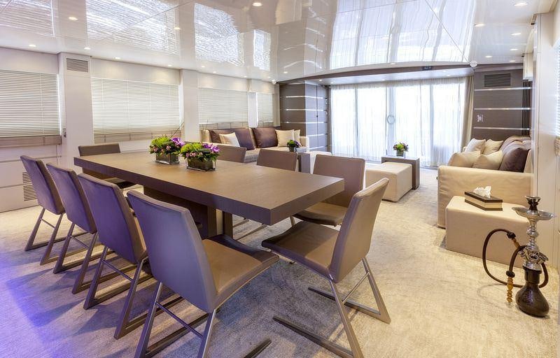 a room with a table chairs and a couch aboard TROPICANA Yacht for Charter