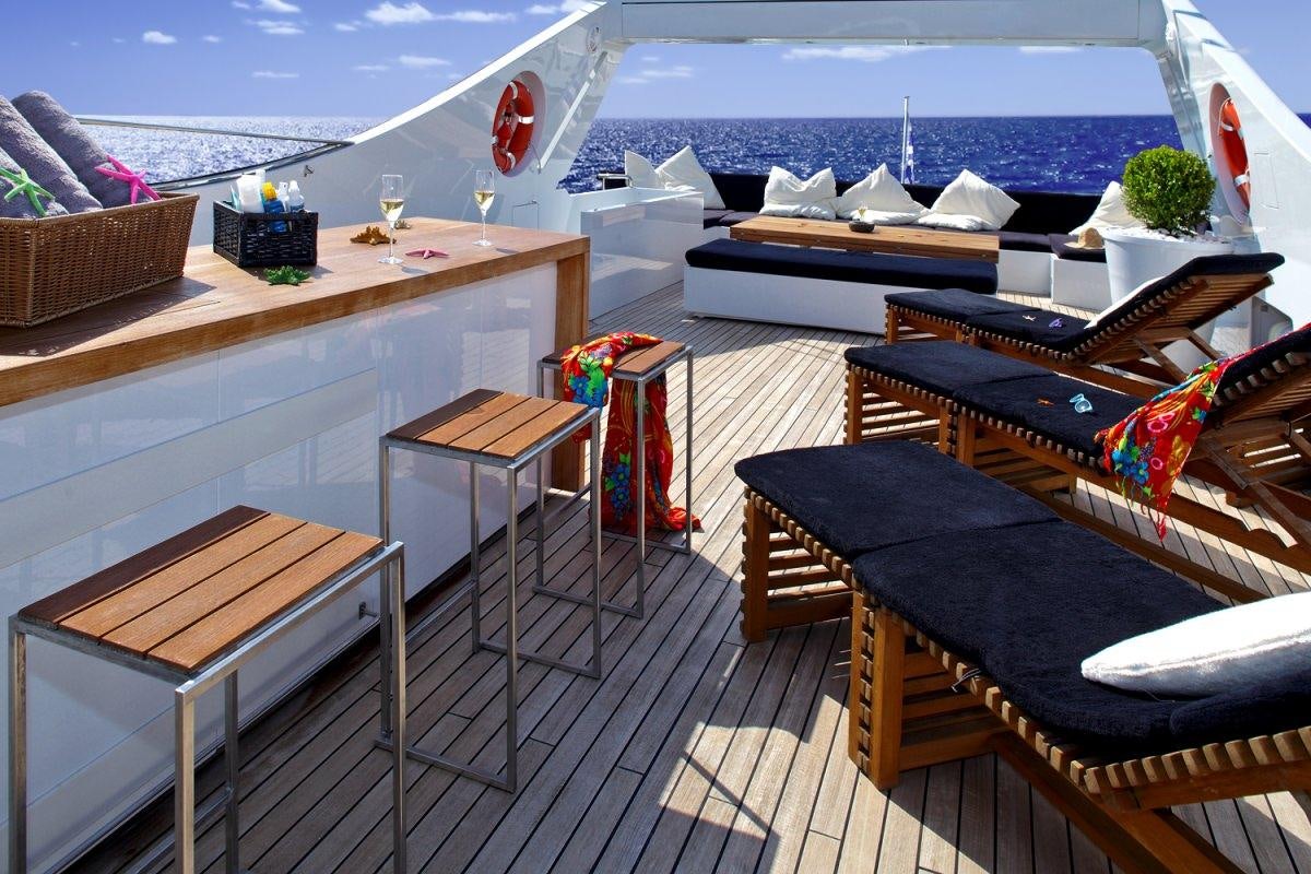 a deck with a view of the ocean and a deck aboard TROPICANA Yacht for Charter