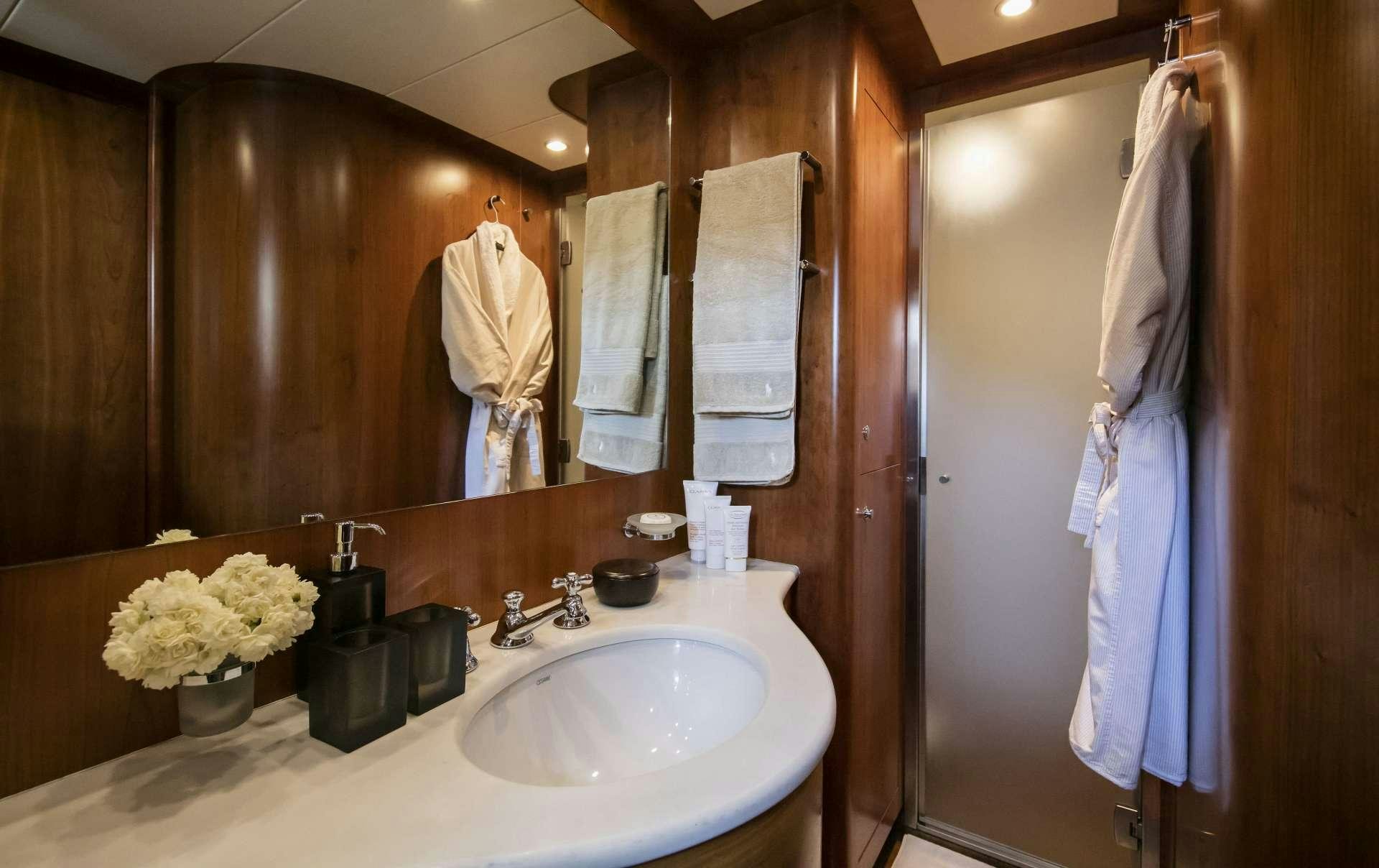 a bathroom with a large mirror aboard VYNO Yacht for Charter